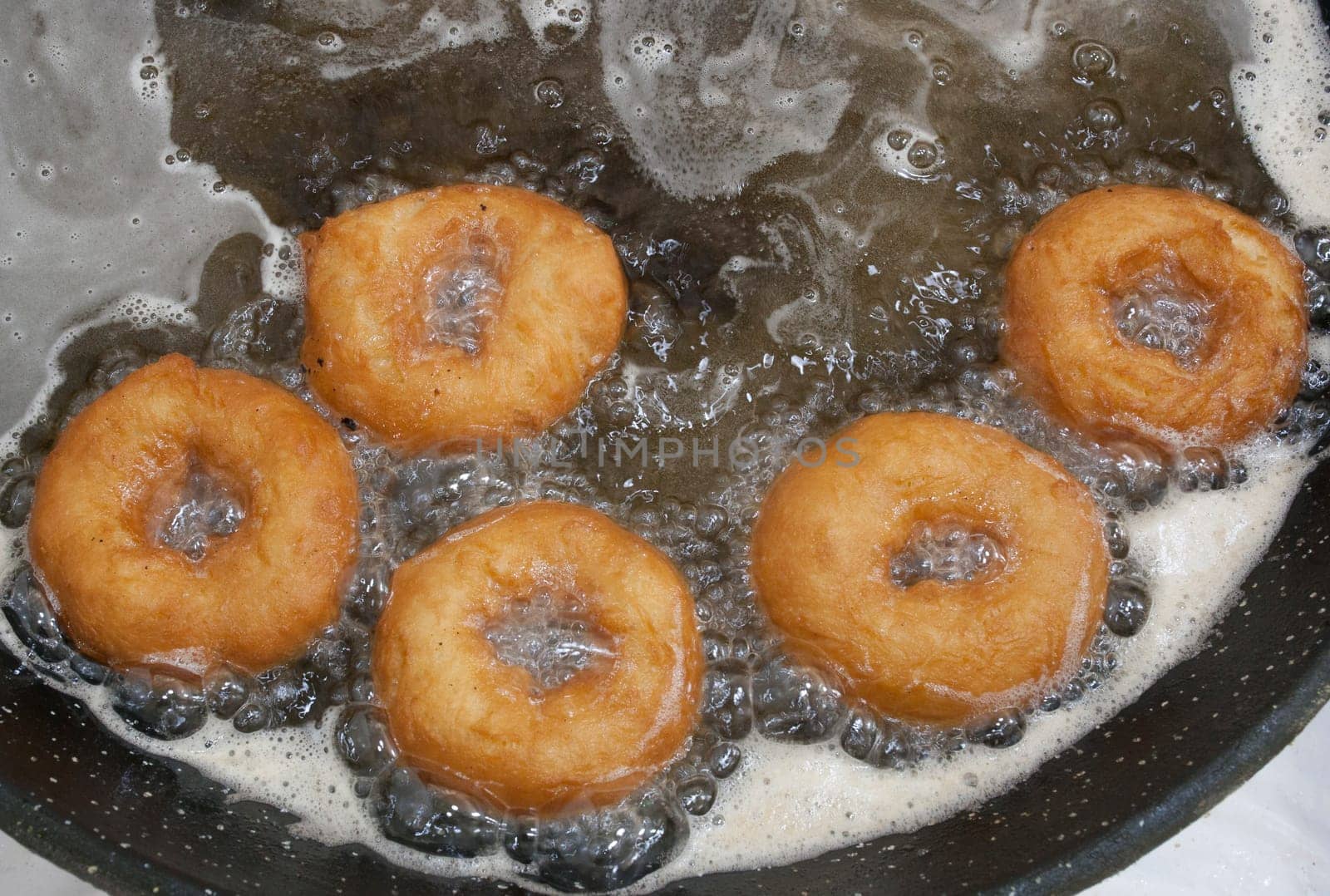 Elaboration process of spanish typical fried donuts or roscas fritas. Overhead view