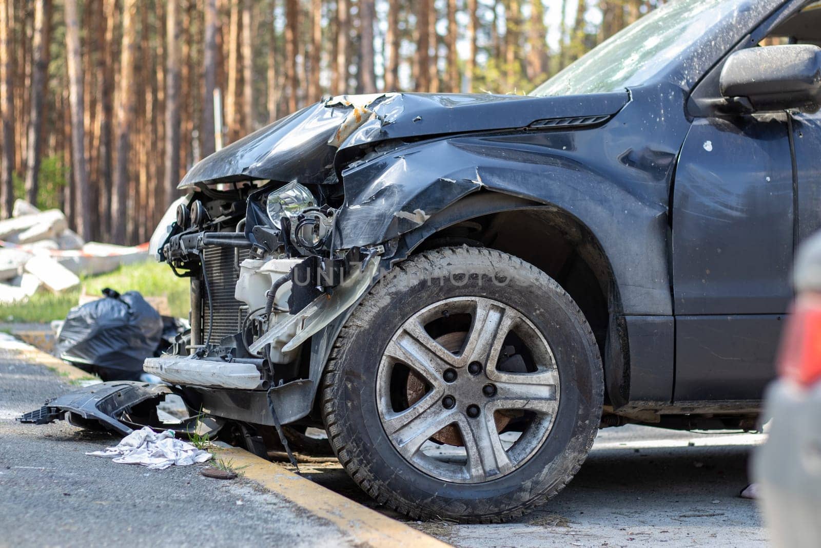 Many broken cars after a traffic accident in the parking lot of a restoration service station on the street. Car body damage workshop outdoors. Sale of insurance emergency vehicles at auction