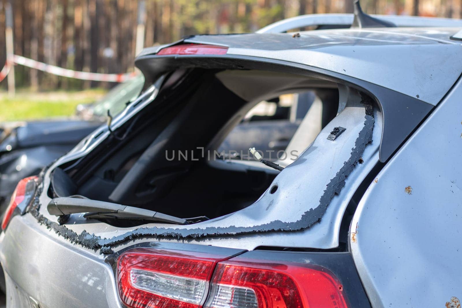 A car after an accident with a broken rear window. Broken window in a vehicle. The wreckage of the interior of a modern car after an accident, a detailed close-up view of the damaged car
