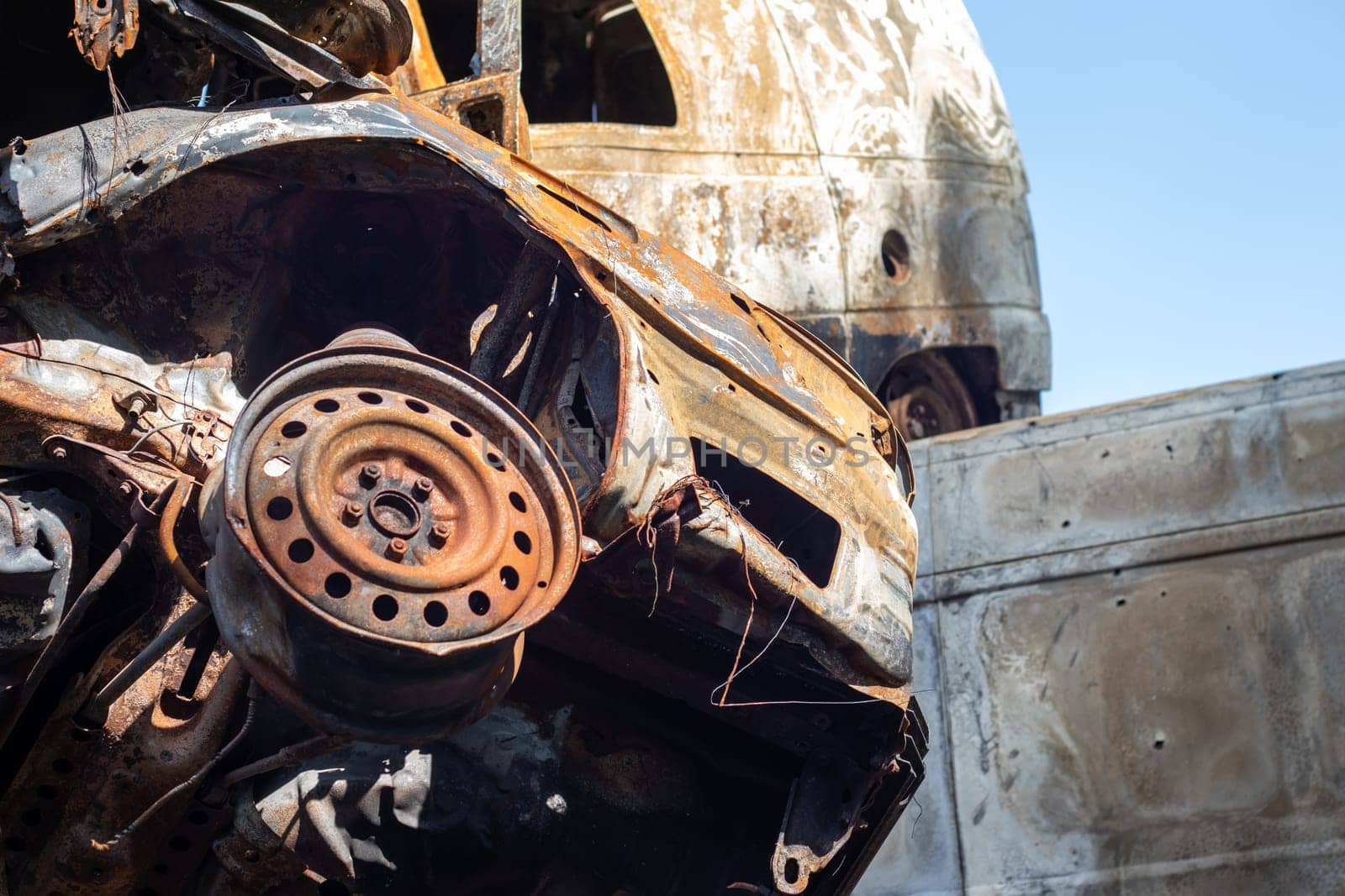 Broken and burned cars in the parking lot, accident or deliberate vandalism. Burnt car. Consequences of a car accident. Damaged by arson. Dump of civilian vehicles shot by Russian troops in Ukraine
