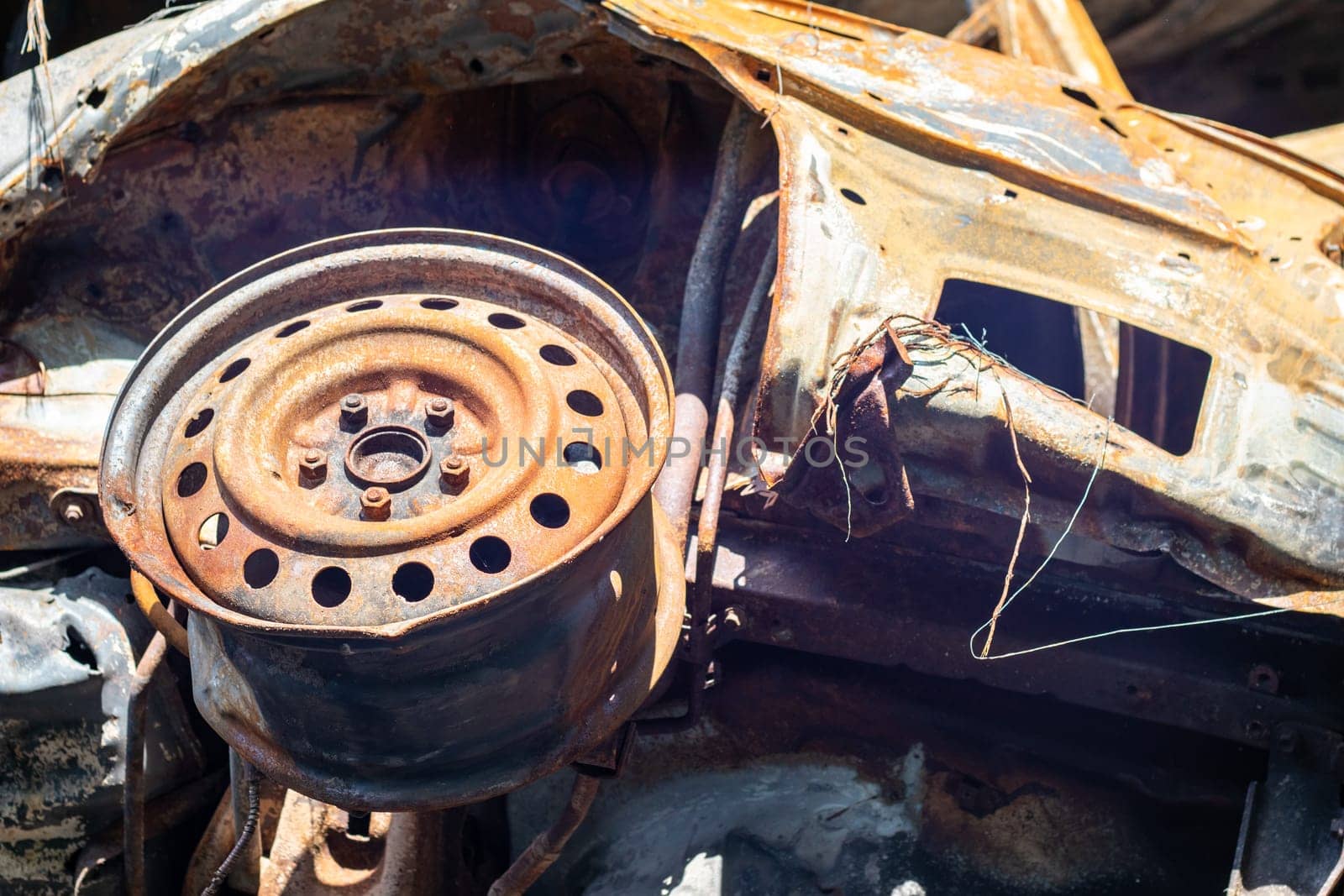 Broken and burned cars in the parking lot, accident or deliberate vandalism. Burnt car. Consequences of a car accident. Damaged by arson. Dump of civilian vehicles shot by Russian troops in Ukraine