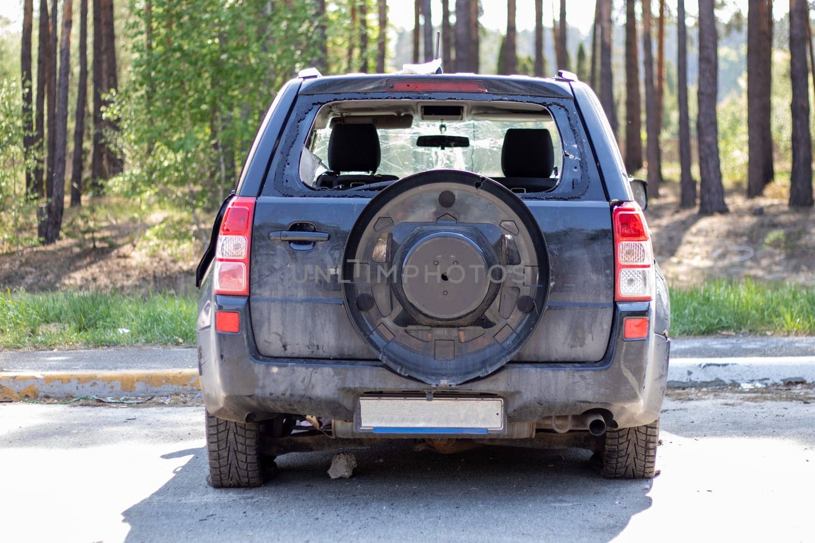 Shot car during the war in Ukraine. A car of civilians with shrapnel holes from explosions. Traces of shots on the body. The car was damaged after the shelling. Ukraine, Irpen - May 12, 2022