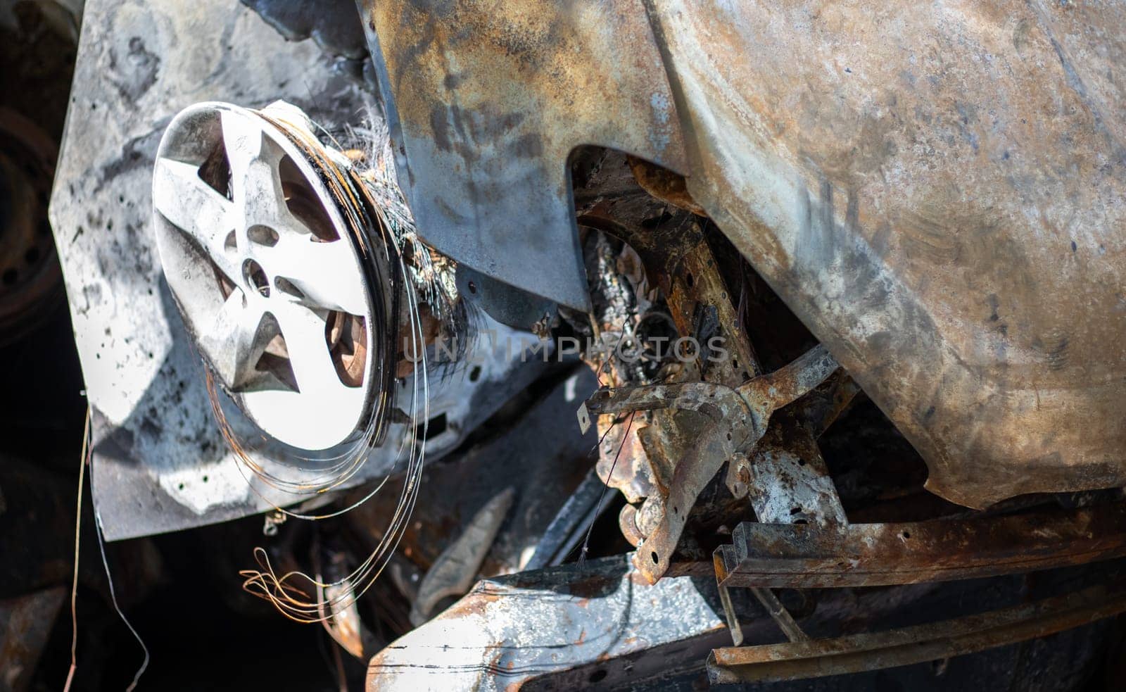 Broken and burned cars in the parking lot, accident or deliberate vandalism. Burnt car. Consequences of a car accident. Damaged by arson. Dump of civilian vehicles shot by Russian troops in Ukraine