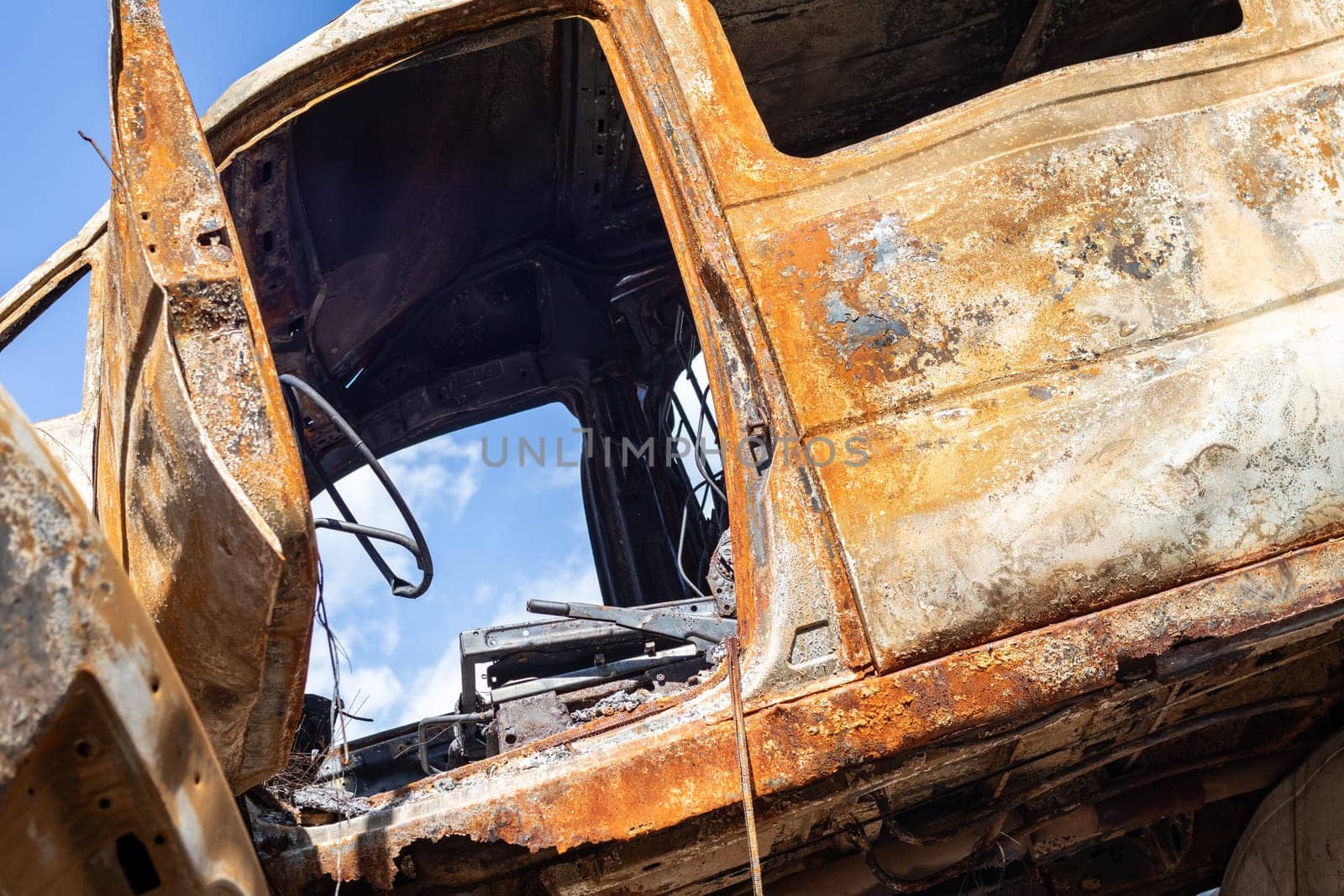 Broken and burned cars in the parking lot, accident or deliberate vandalism. Burnt car. Consequences of a car accident. Damaged by arson. Dump of civilian vehicles shot by Russian troops in Ukraine