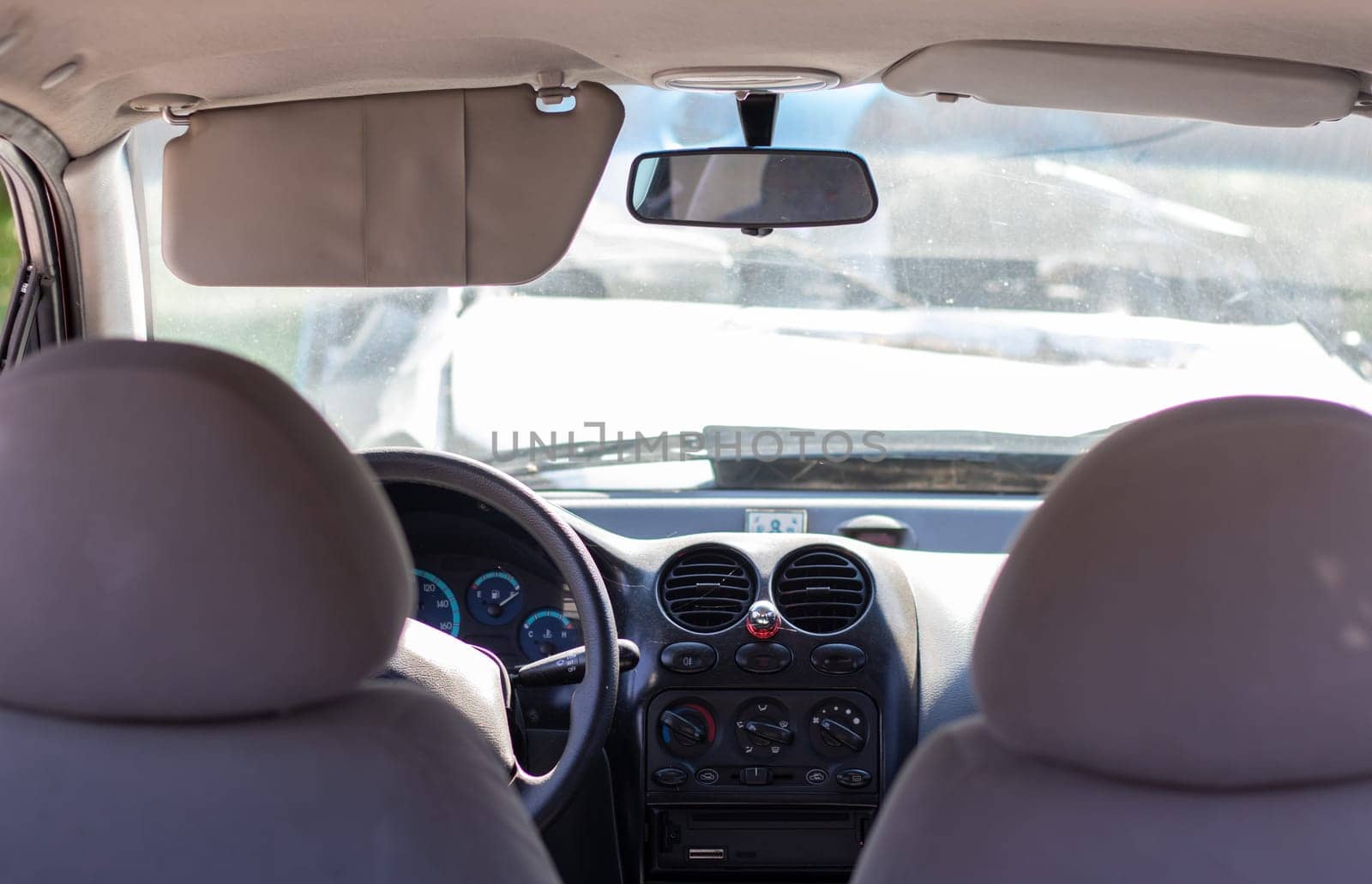 Damaged car window after an accident. Broken windshield as a result of an accident, inside view. Cabin interior details, view from the cab. Safe movement. Broken windshield. Glass crack and damage