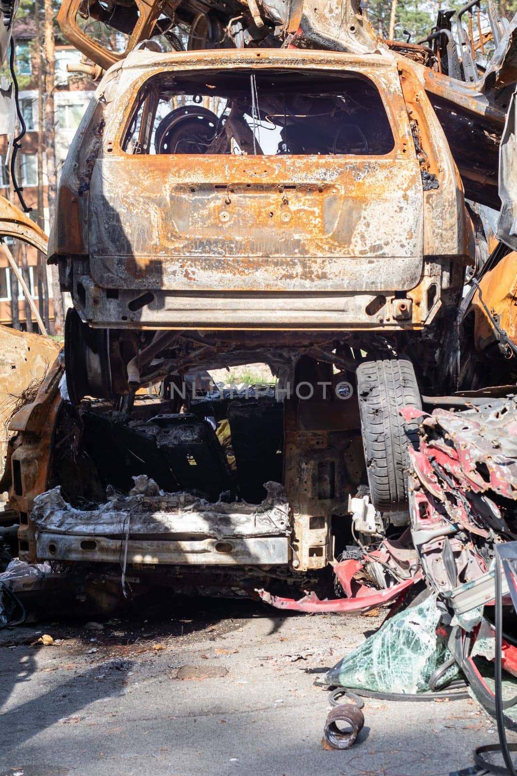 A lot of rusty burnt cars in Irpen, after being shot by the Russian military. Russia's war against Ukraine. Cemetery of destroyed cars of civilians who tried to evacuate from the war zone