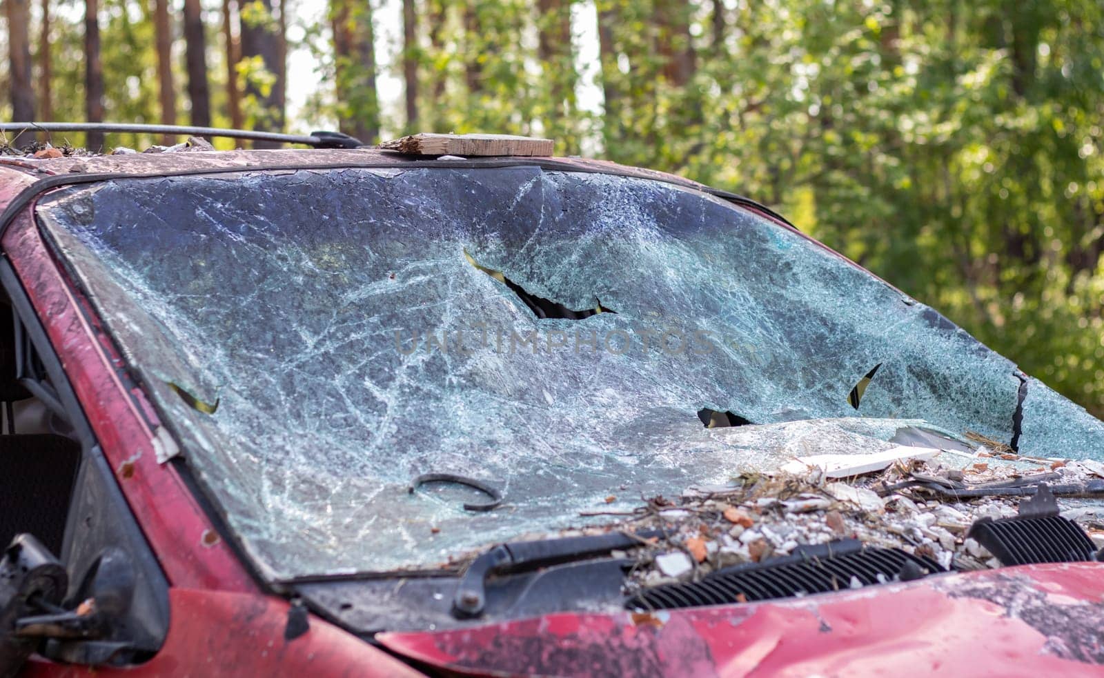 Close-up of a car with a broken windshield after a fatal crash. Consequence of a fatal car accident. Automobile danger. Reckless dangerous driving. Vehicle after an accident with a pedestrian