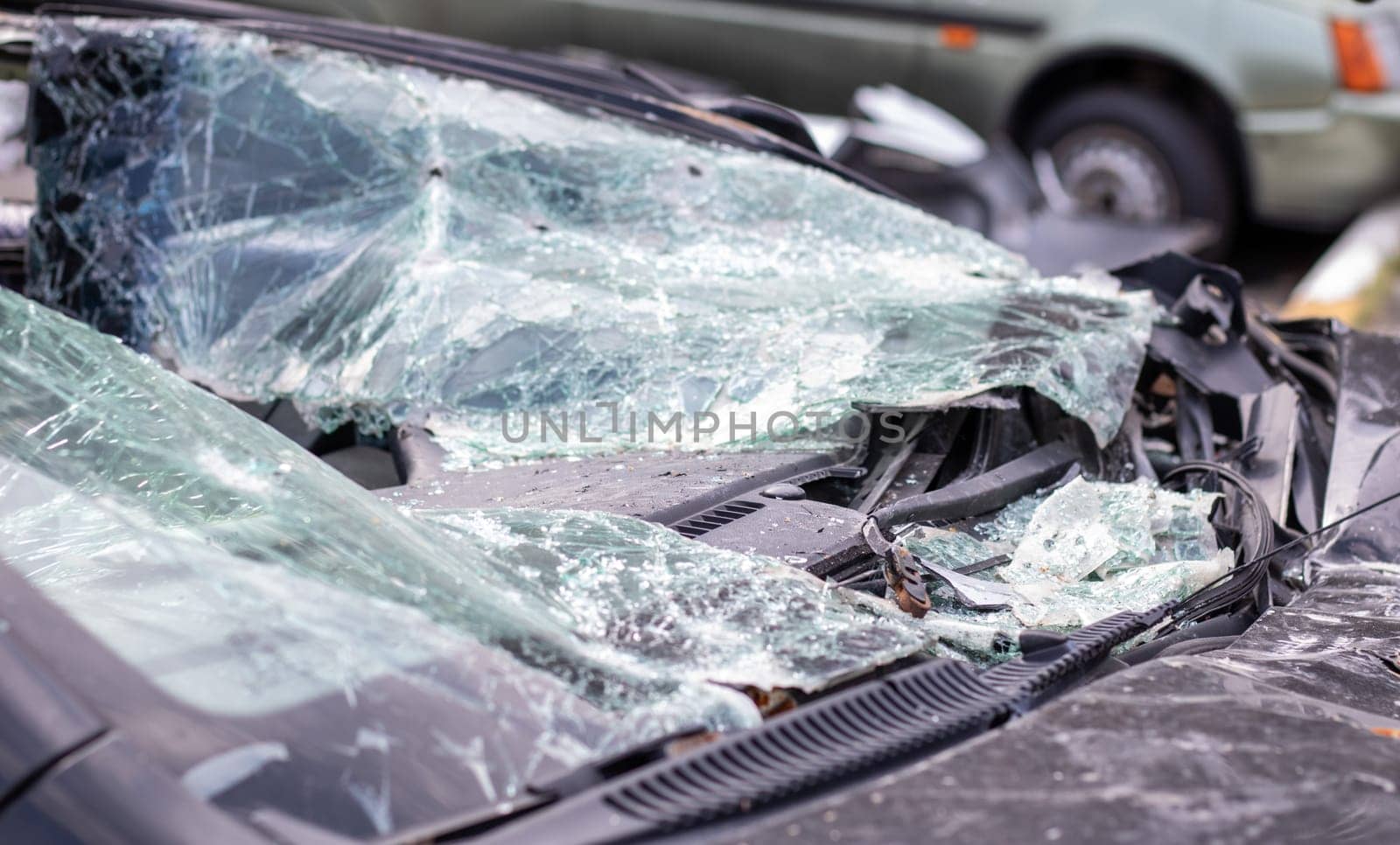 Close-up of a car with a broken windshield after a fatal crash. Consequence of a fatal car accident. Automobile danger. Reckless dangerous driving. Vehicle after an accident with a pedestrian
