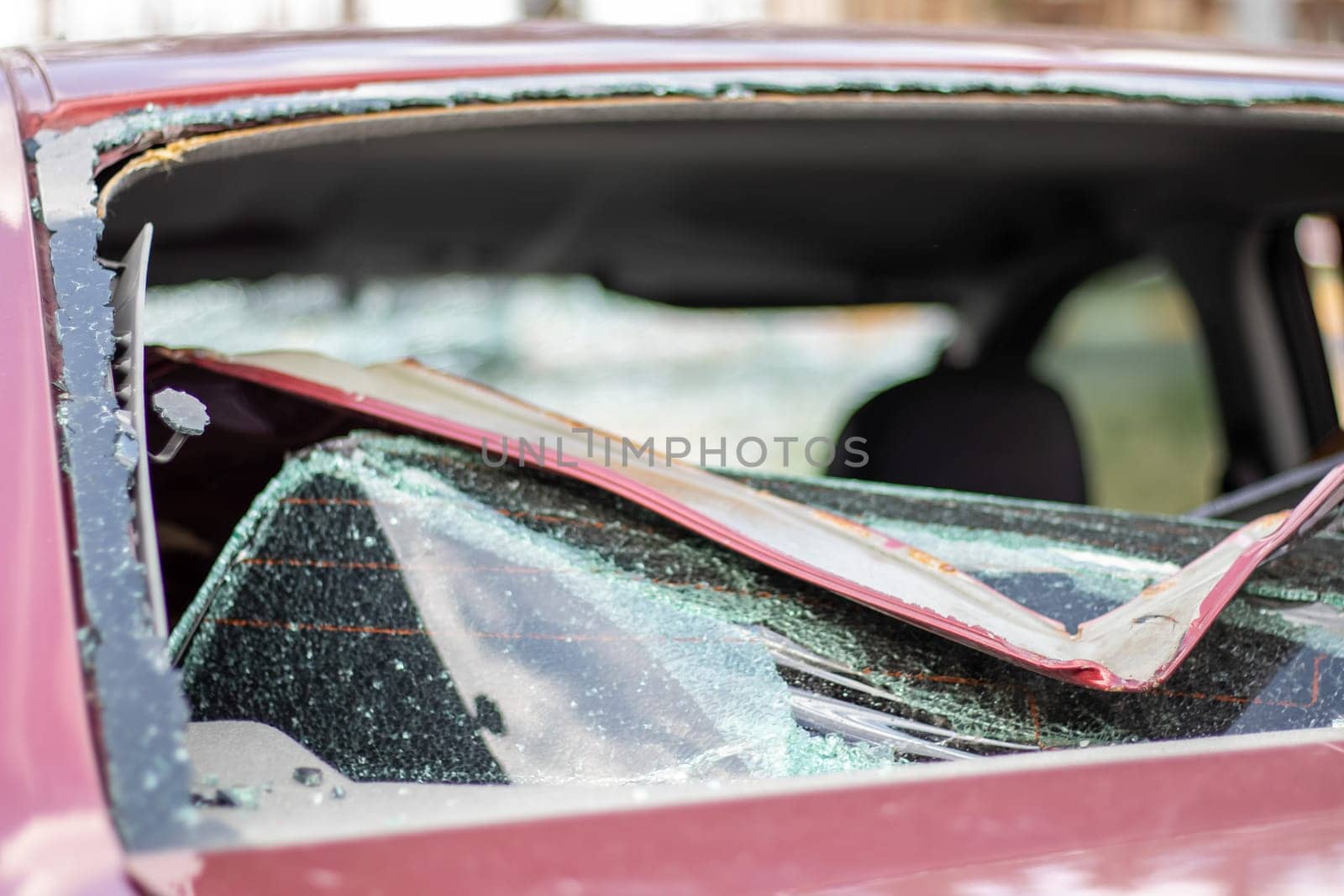 A car after an accident with a broken rear window. Broken window in a vehicle. The wreckage of the interior of a modern car after an accident, a detailed close-up view of the damaged car