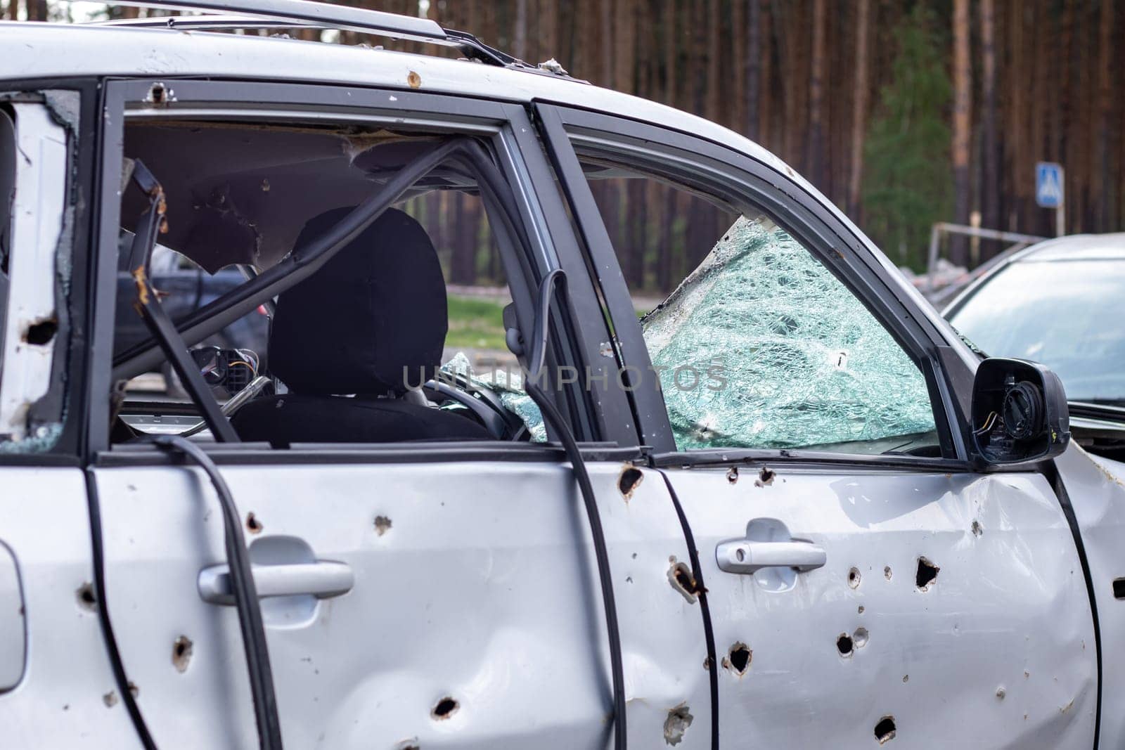 Car riddled with bullets. War of Russia against Ukraine. A car of civilians shot by the Russian military during the evacuation of women and children. Traces of bullets and fragments of shells