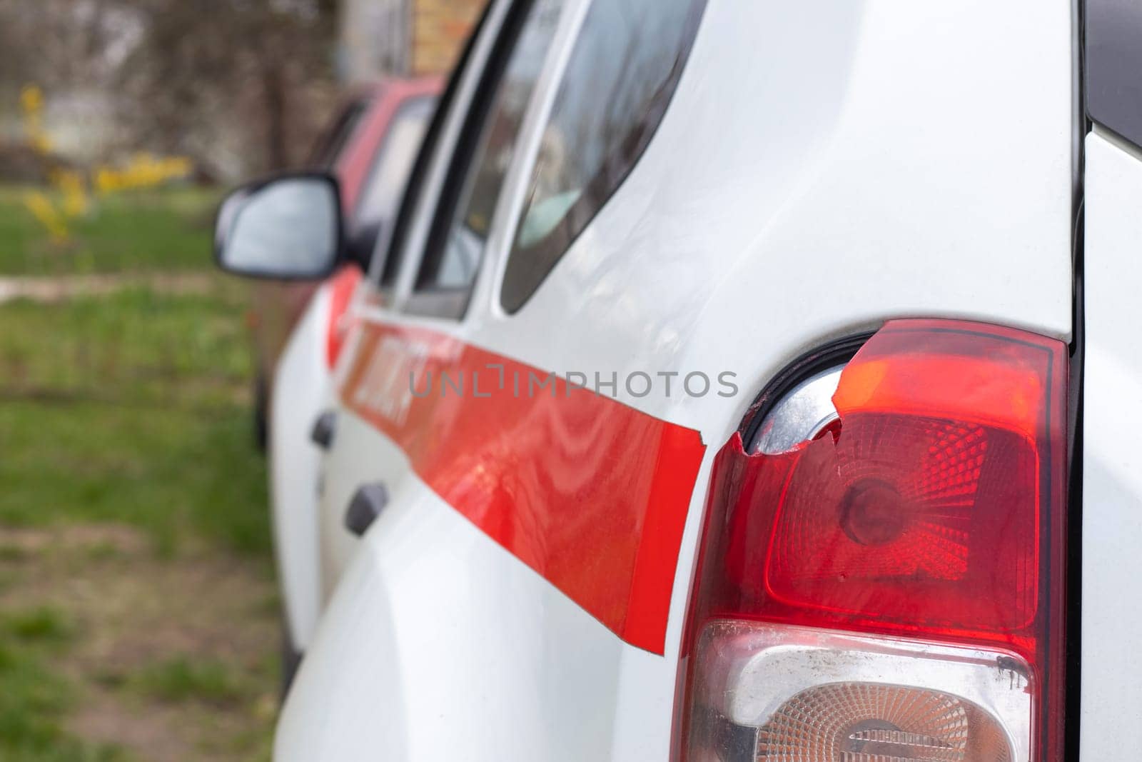 The rear left lamp of a white car is broken. The taillight of the car was shattered in the accident. Damage accident. Security concept. Rear stop of a car in an accident close-up