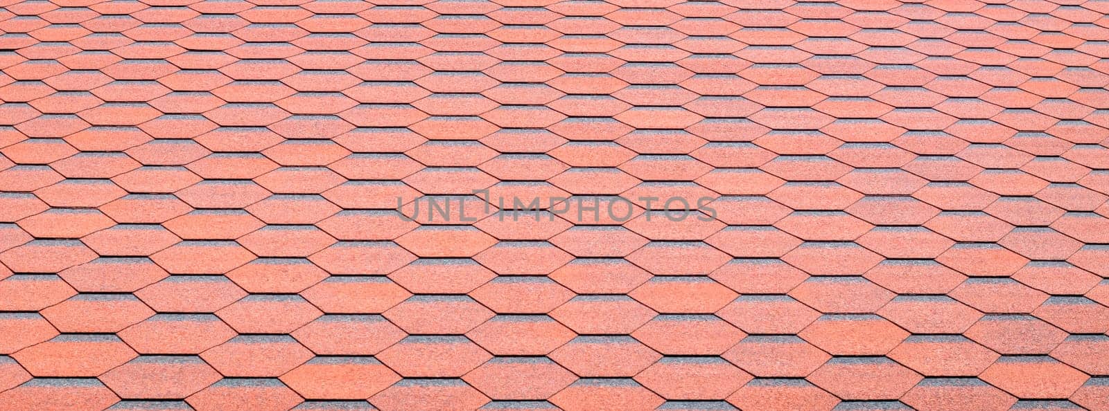 New roof with red shingles. Tiles on the roof of the house. Use to advertise roof fabrication and maintenance. Spotted texture. Affordable roofing. Banner with copy space