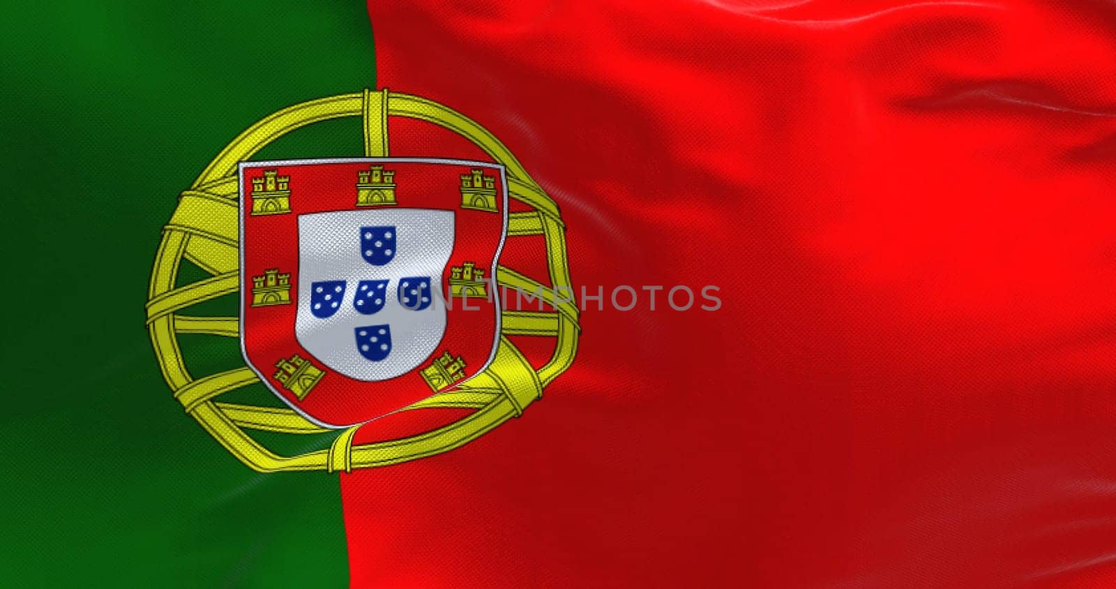 Detail of the national flag of Portugal waving in the wind on a clear day. Democracy and politics. European country. Selective focus
