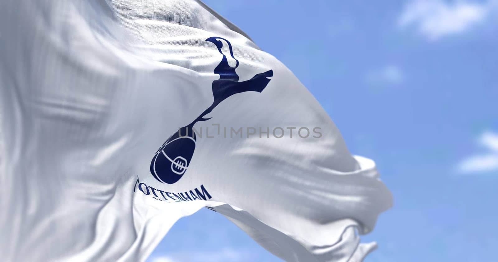 London, UK, May 2022: The flag of Tottenham Hotspur Club waving in the wind on a clear day. Tottenham Hotspur is a professional football club based in Tottenham, London