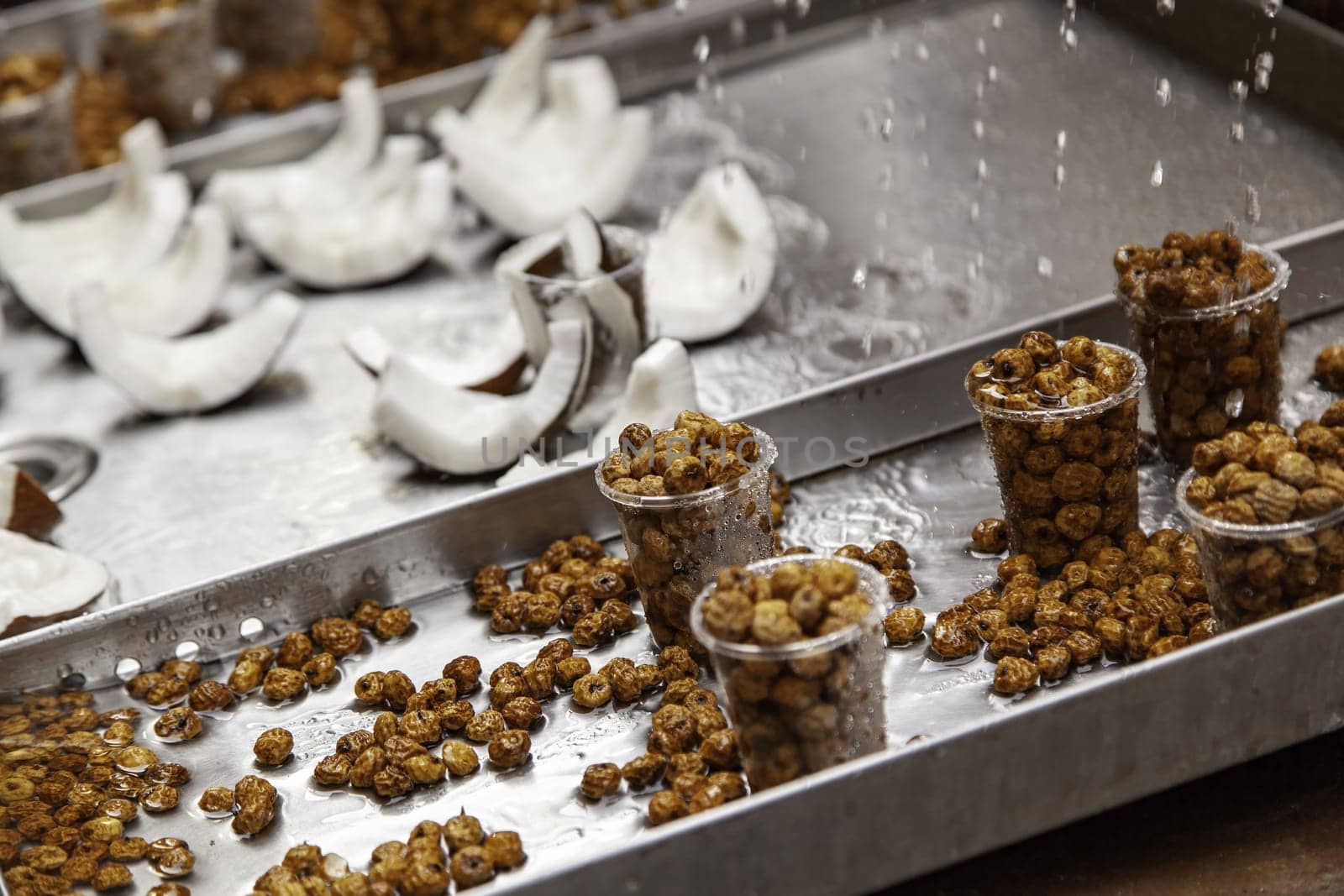 Detail of coconut pieces and dried tiger nuts at a fair, healthy food