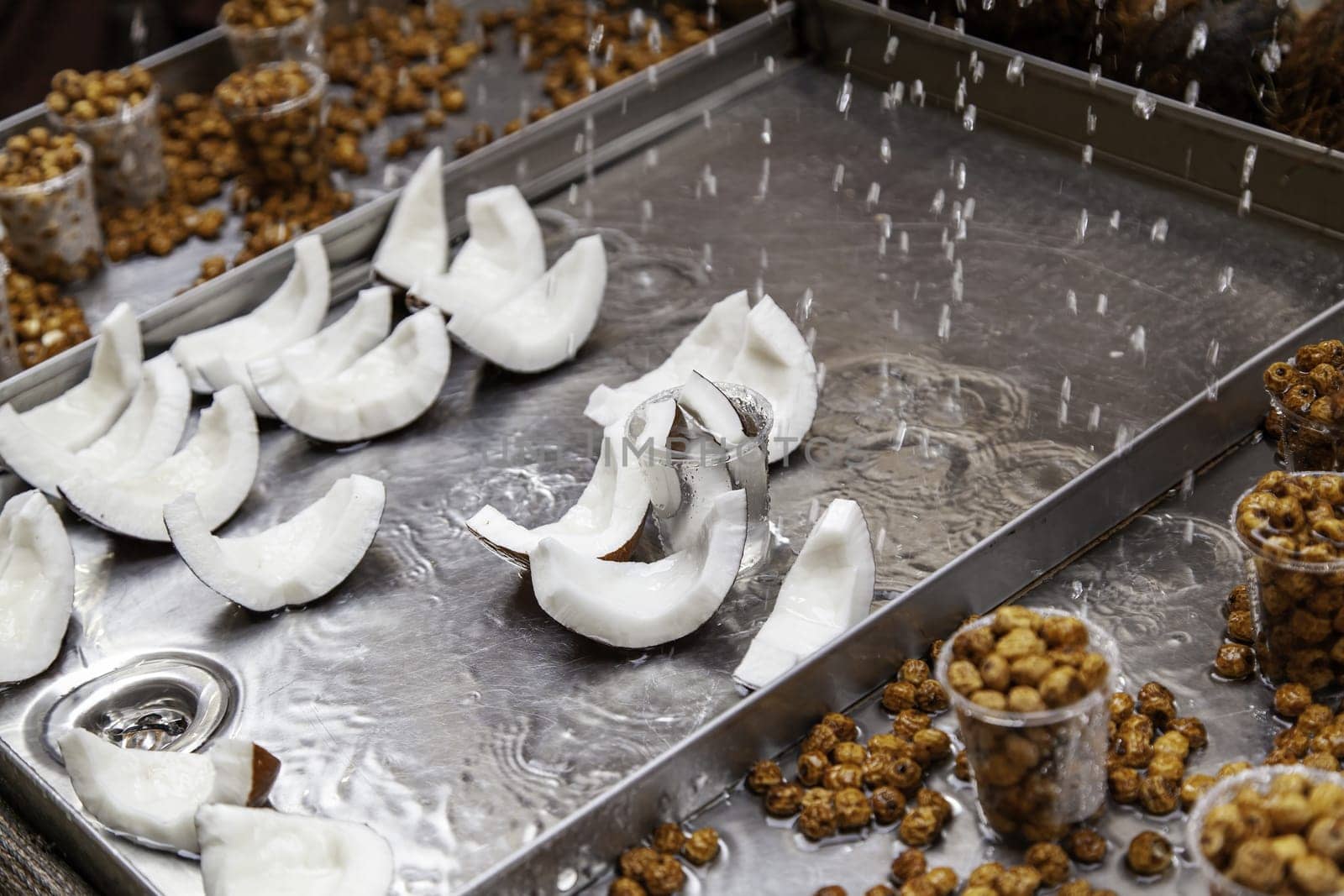 Detail of coconut pieces and dried tiger nuts at a fair, healthy food