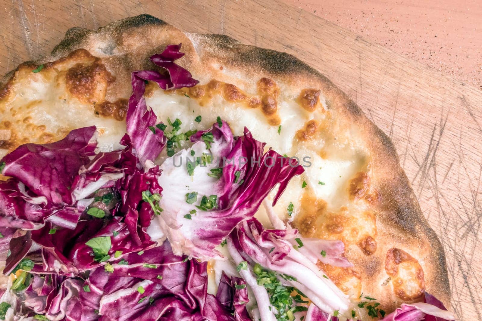 Italian pizza with mozzarella and radicchio salad. Shallow DOF.
