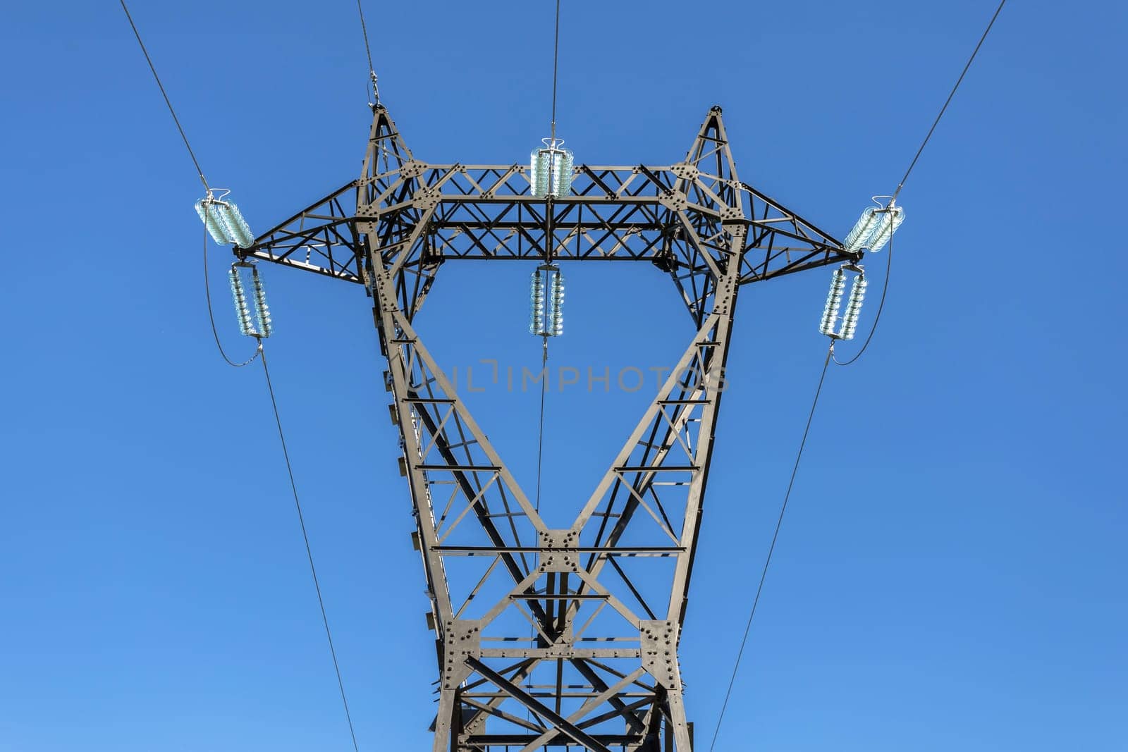 Electric poles and lines high voltage on a blue sky background.