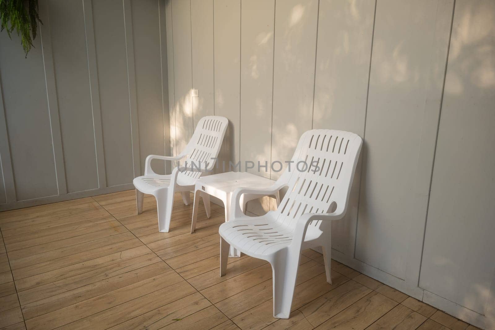 Nobody white chair around outdoor swimming pool in resort hotel empty behind the room for leisure travel vacation