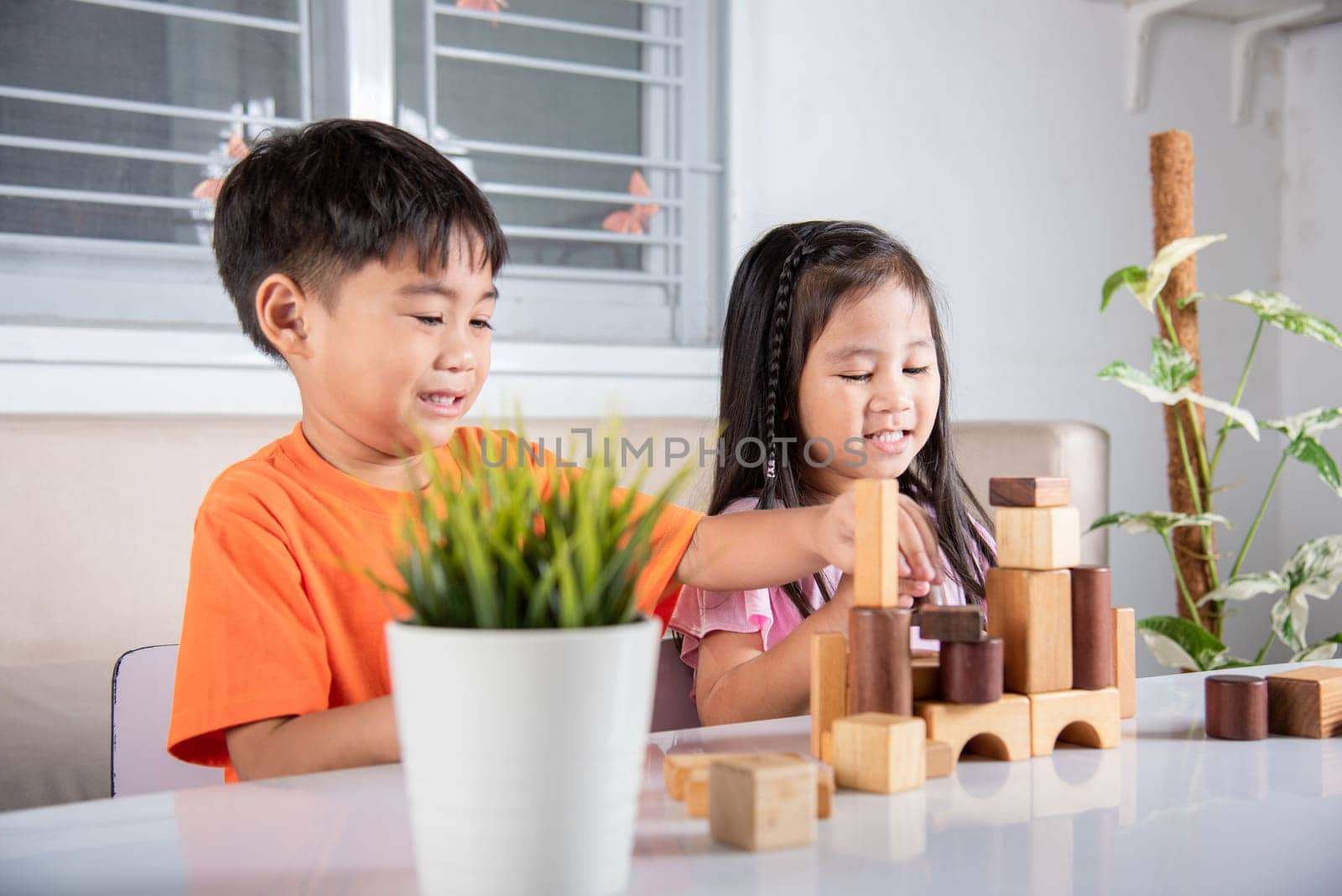 Happy little kids play wood block stacking board game at home, Children boy and girl playing with constructor wooden block, childhood activities learning creative, toys for preschool and kindergarten