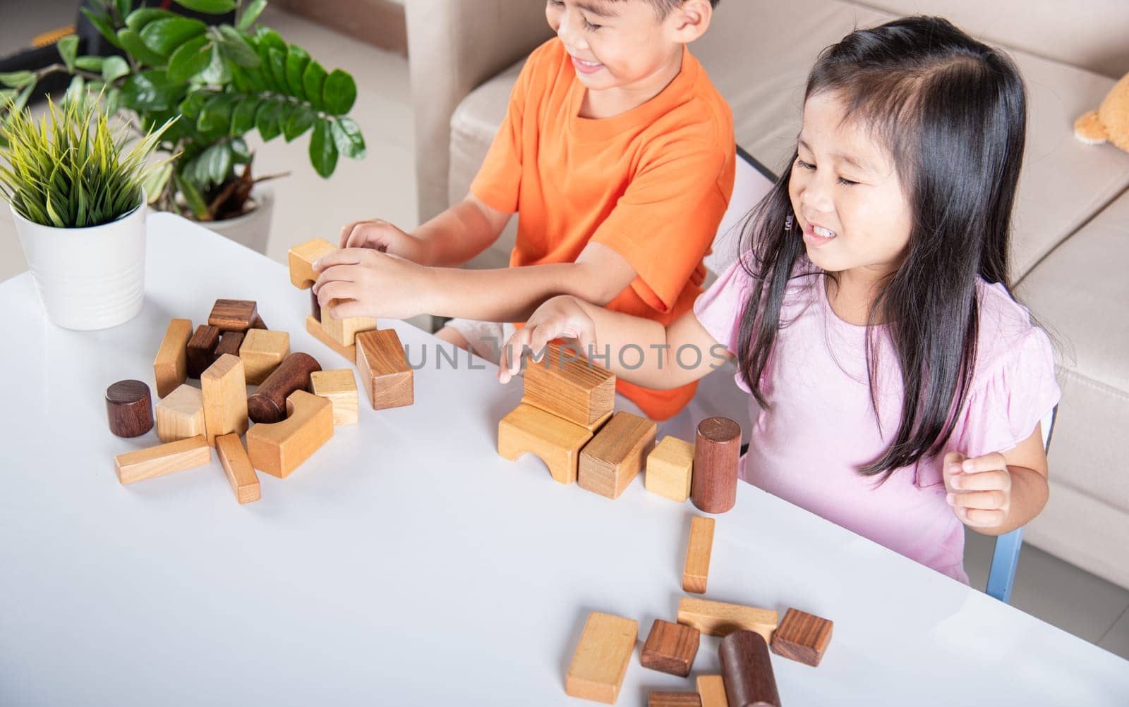 Happy little kids play wood block stacking board game at home, Children boy and girl playing with constructor wooden block, childhood activities learning creative, toys for preschool and kindergarten