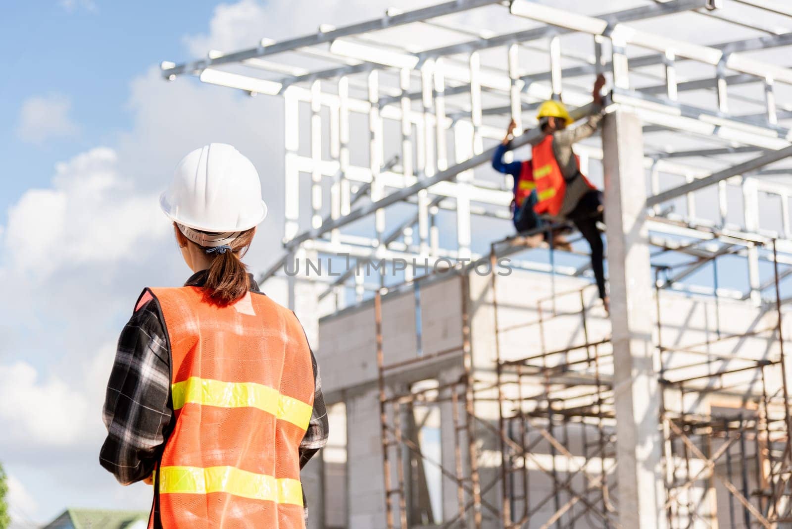 Back one architect standing outdoor at home building construction site. Asian engineer foreman worker woman, Home building Project quality Inspection