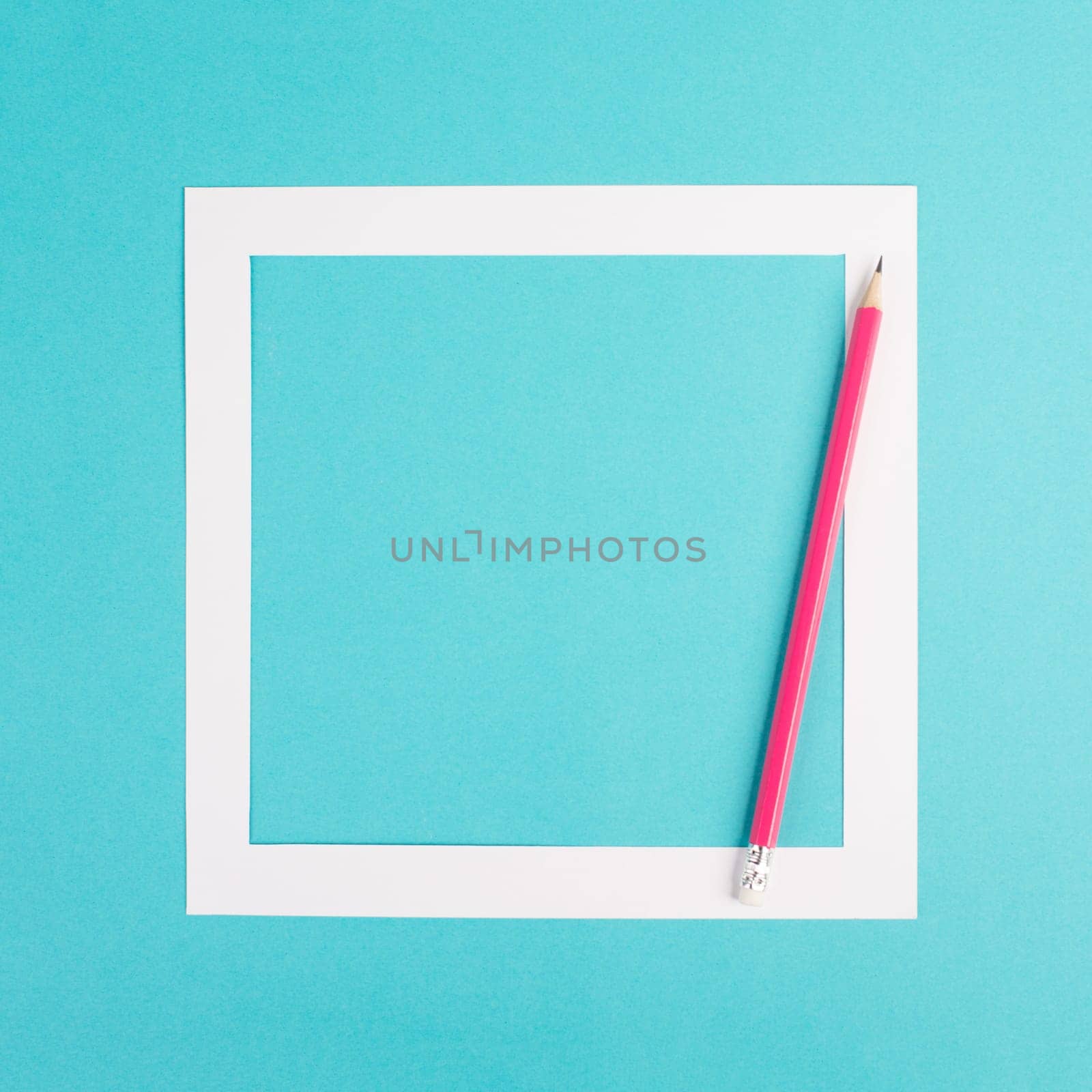 Pencils on a blue paper background, white frame with copy space for text, minimalism, creative and business concept, pastel colored