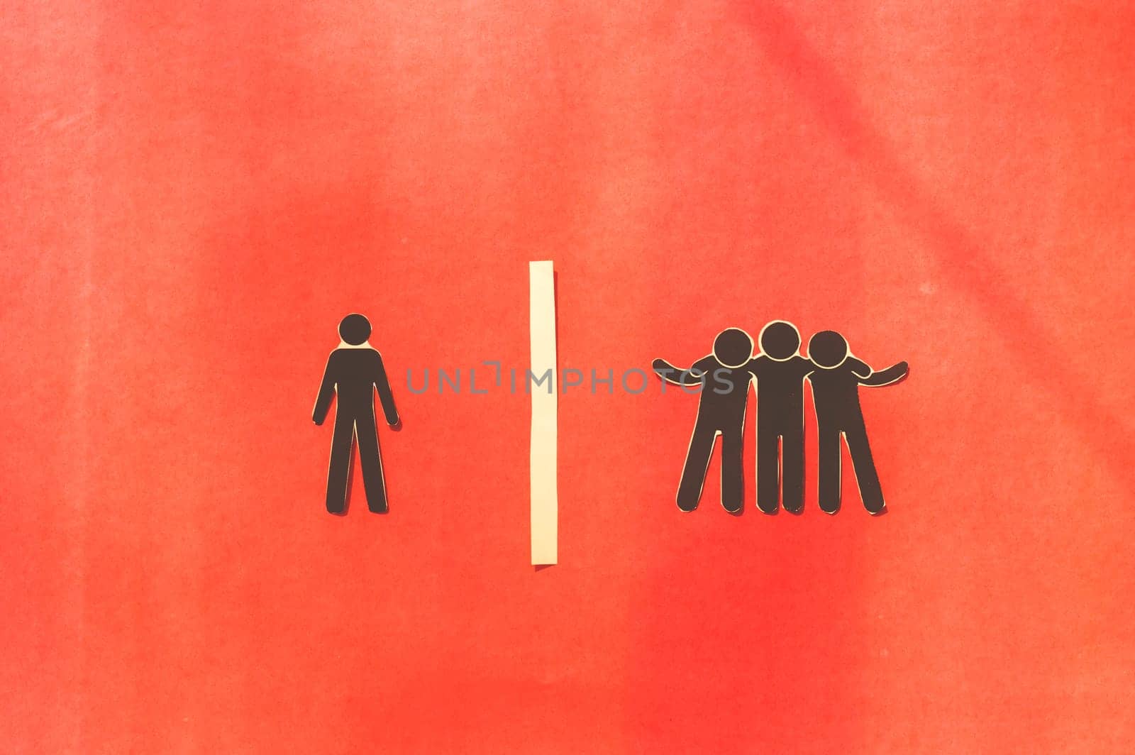 Paper man standing Isolated from group. Feel Left out and alone. Social isolation and Rejection concepts.