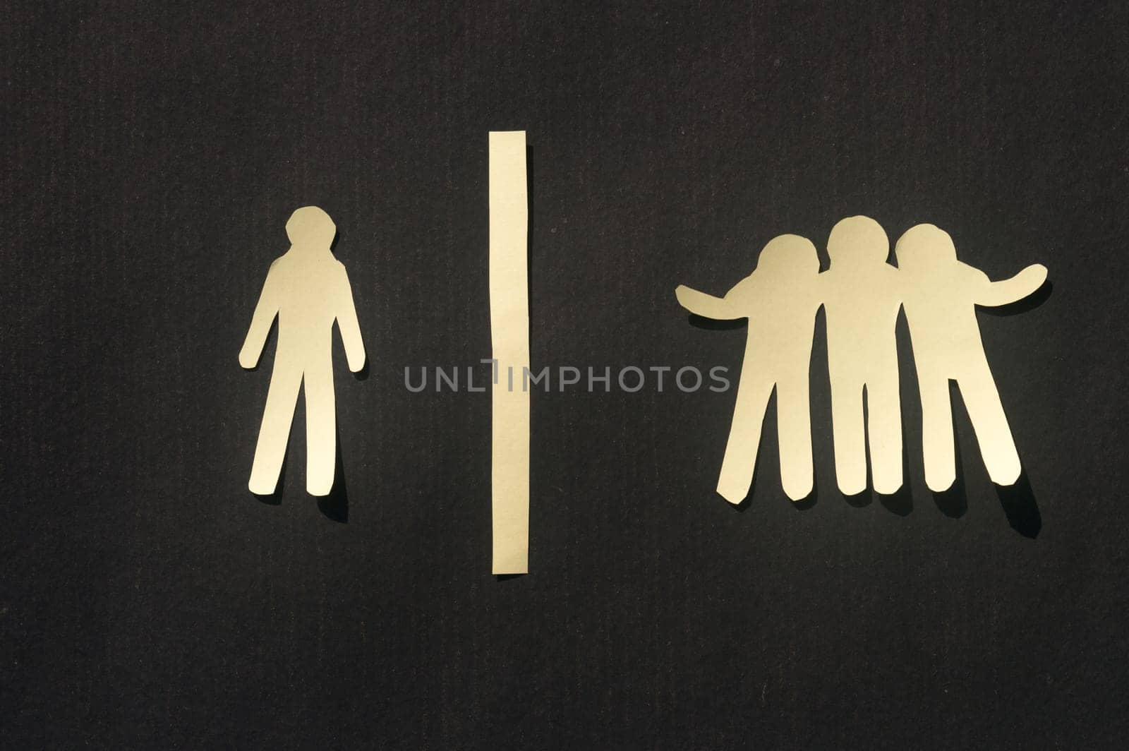 Paper man standing Isolated from group. Feel Left out and alone. Social isolation and Rejection concepts.