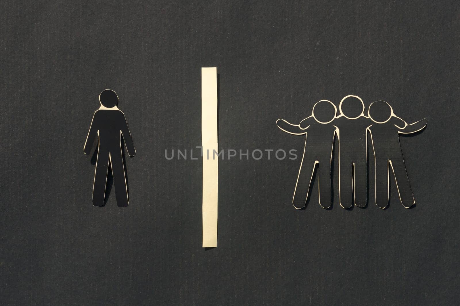 Paper man standing Isolated from group. Feel Left out and alone. Social isolation and Rejection concepts.