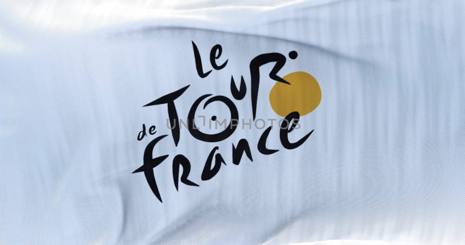Paris, France, June 2022: Flag with the Tour de France logo waving. The Tour de France is the most important cycling event of the year and one of the most important sporting events in the world