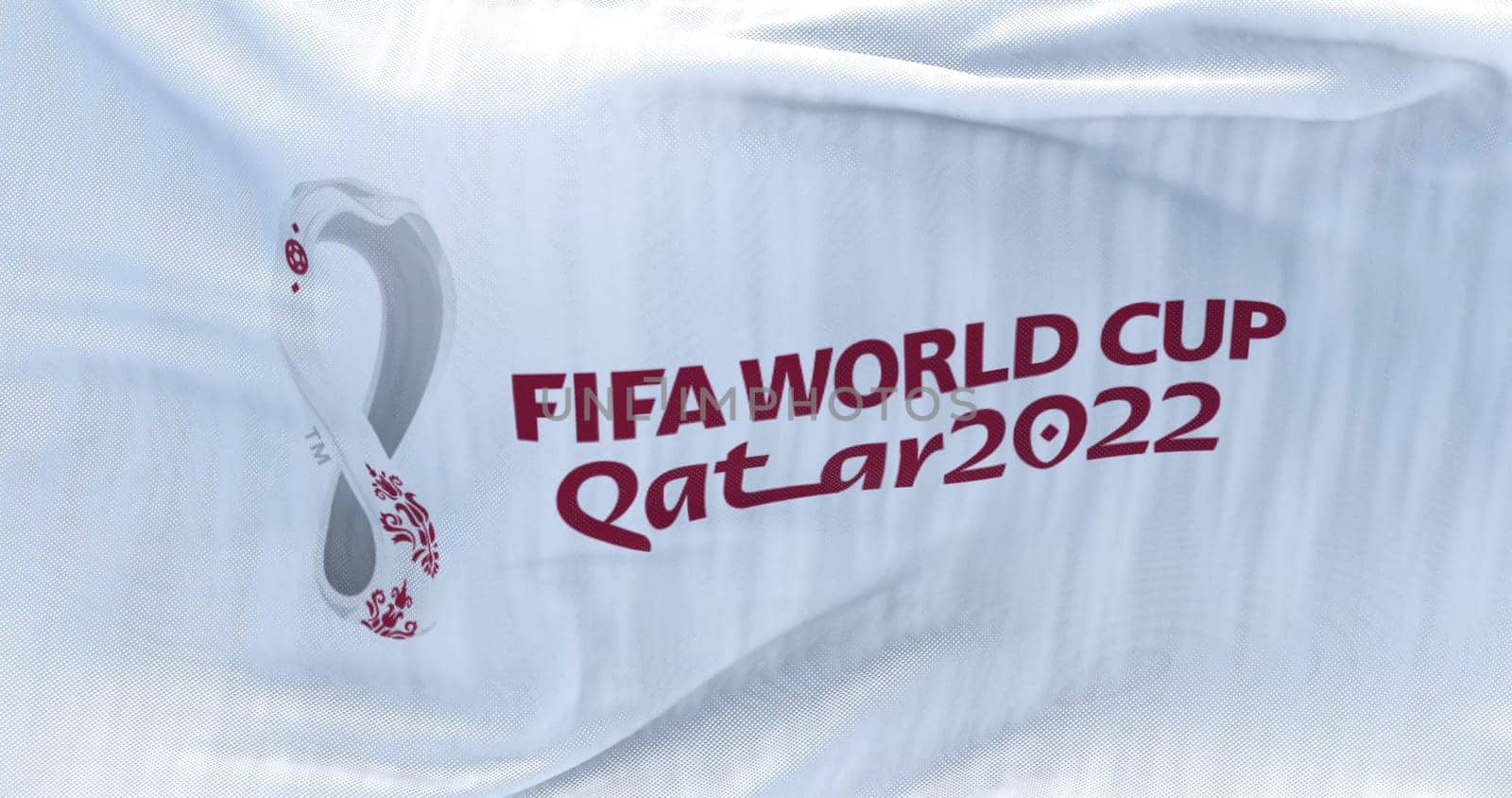 Doha, Qatar, October 2021: Flag with the 2022 Fifa World Cup logo flapping in the wind. The event is scheduled in Qatar from 21 November to 18 December 2022