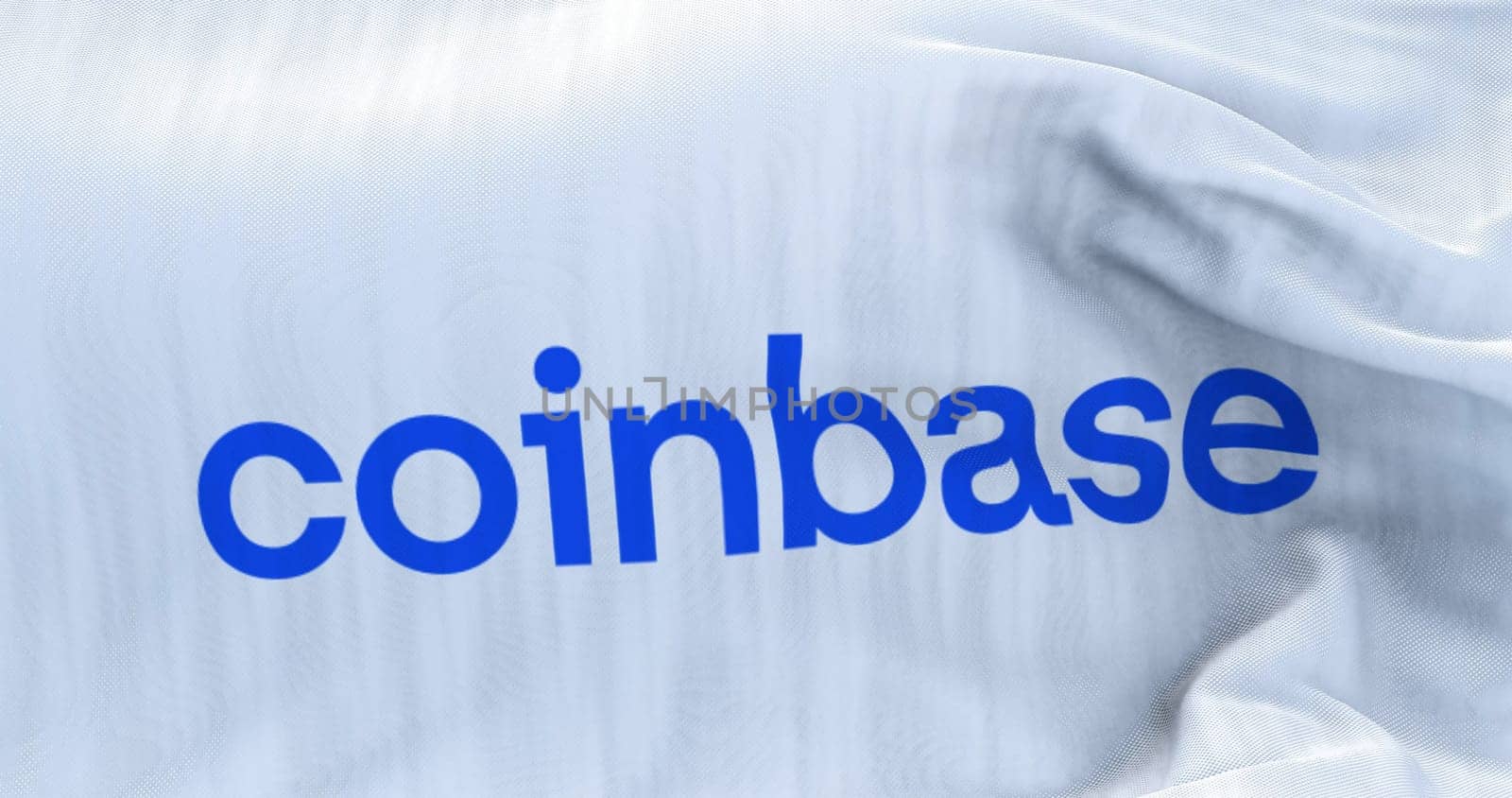 New York, USA, June 2022: White flag with Coinbase logo waving. Coinbase is an American company that operates a cryptocurrency exchange platform