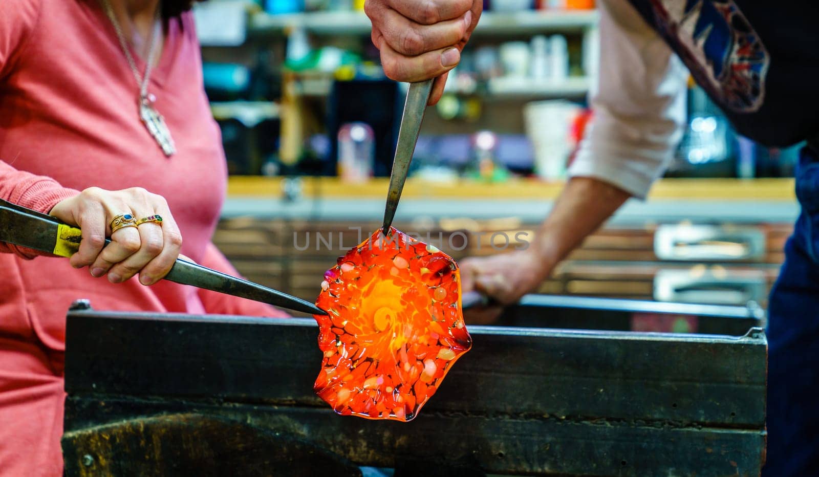 Making a glass flower in a glassblowing workshop