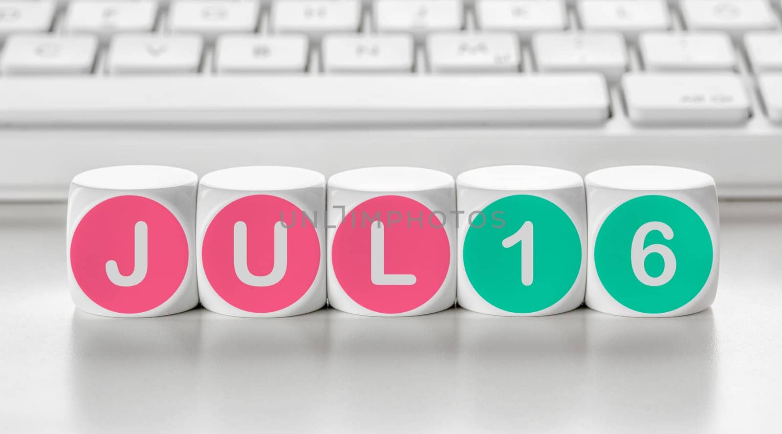 Letter dice in front of a keyboard - July 16