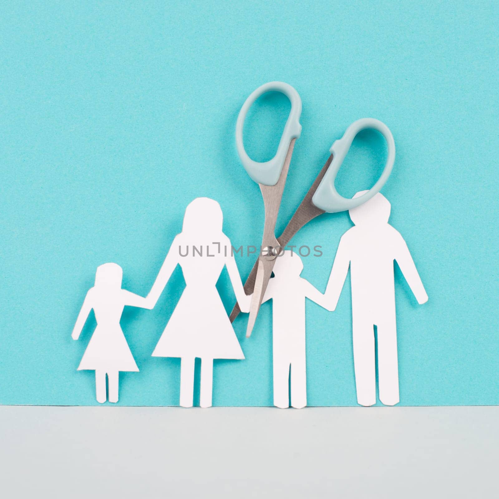 Divored parents, custody battle for the children, scissors cut the family, paper cut out, conflict in relationship, broken marriage concept