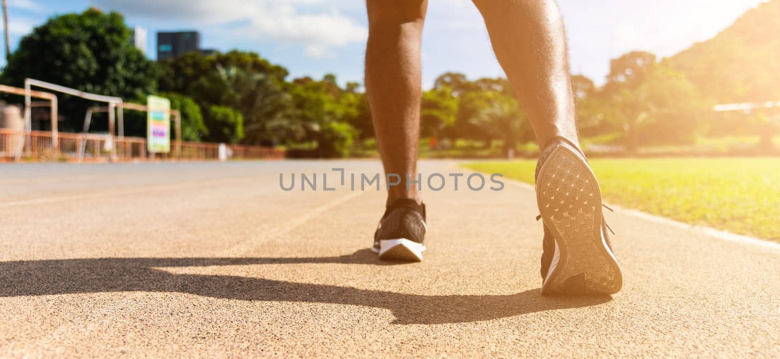 Asian young athlete sport runner black man wear feet active ready to running training at the outdoor on the treadmill line road for a step forward, healthy exercise workout, closeup back shoe