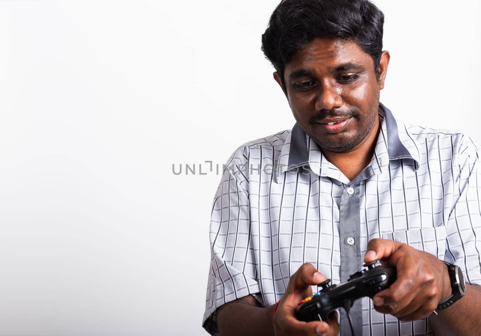 Asian happy portrait young black man funny use hand playing video game pad joystick controller, studio shot isolated on white background