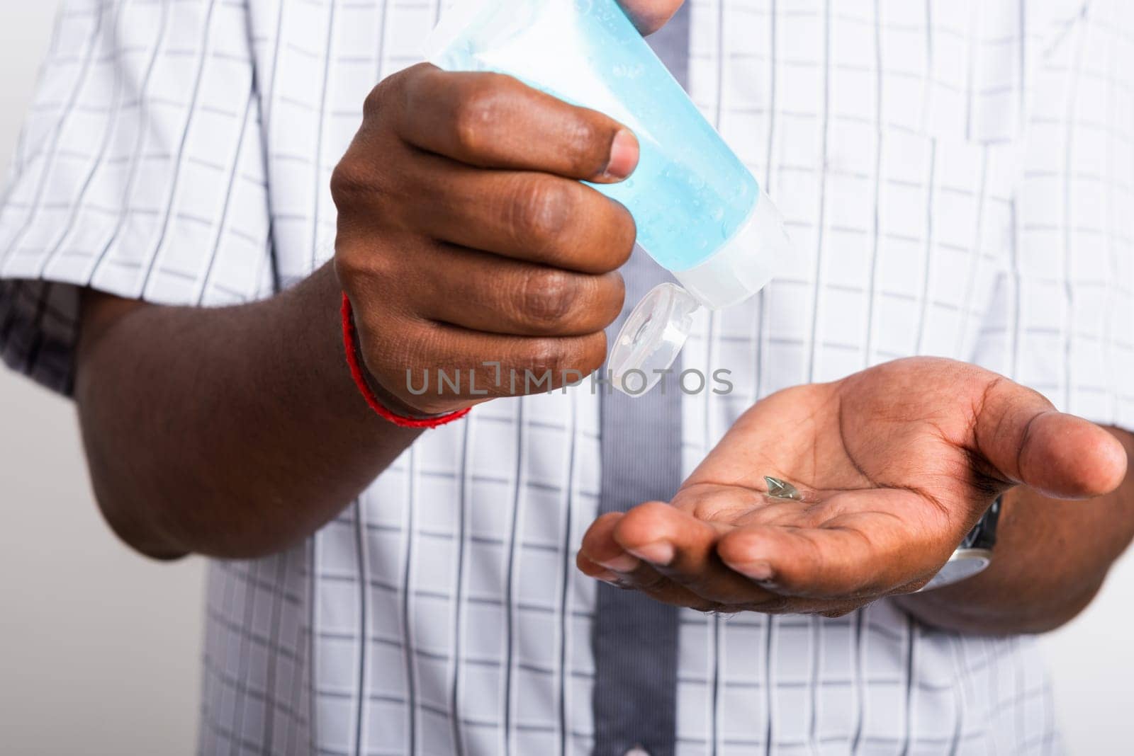 Closeup Asian black man wearing protective face mask  use sanitizer gel face clean his hand, hygiene prevention COVID-19 virus or coronavirus protection concept isolated on white background