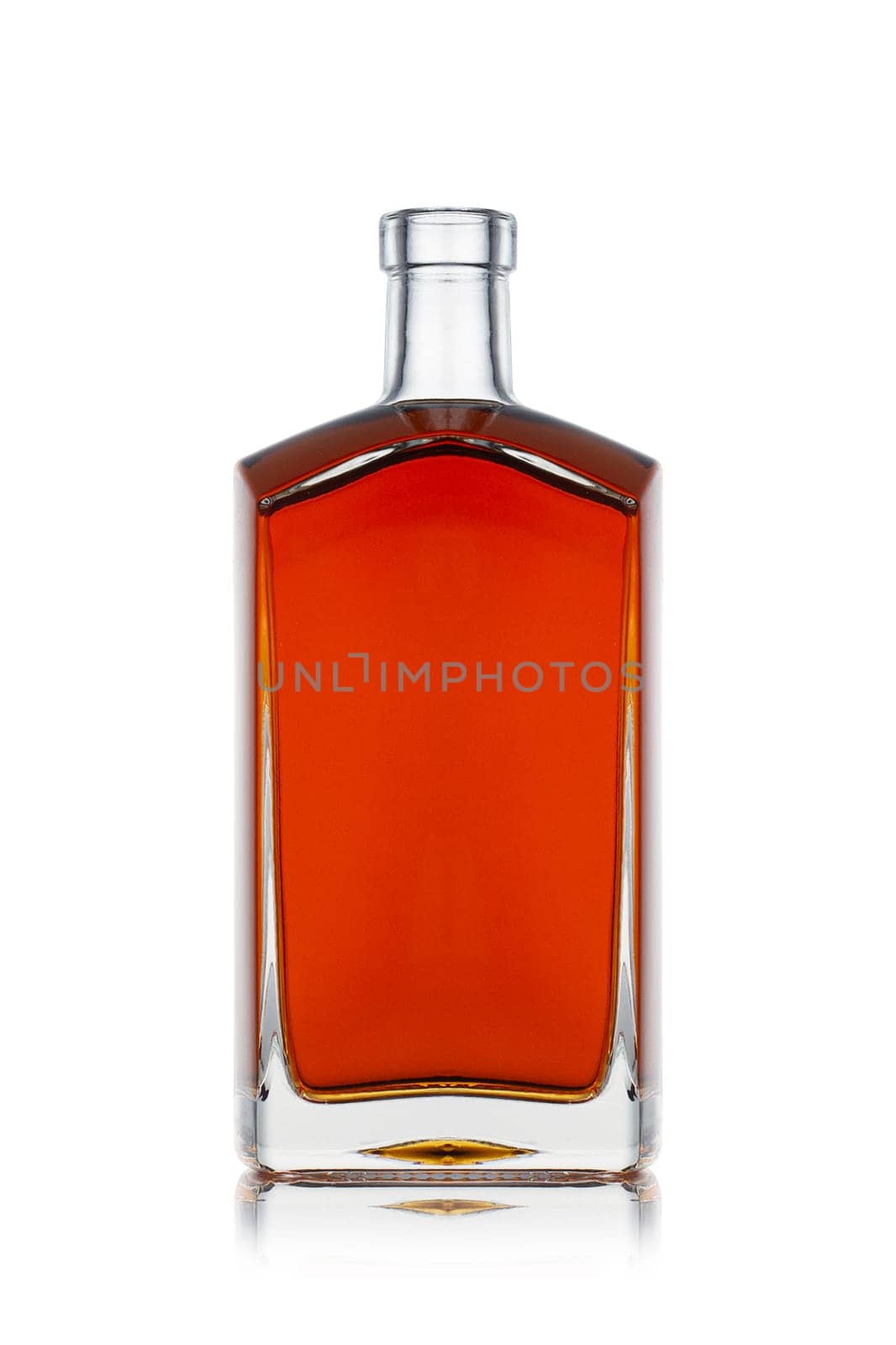 front view closeup of square modern shape cognac brandy bottle with no label isolated and amber liquid on white background with reflection