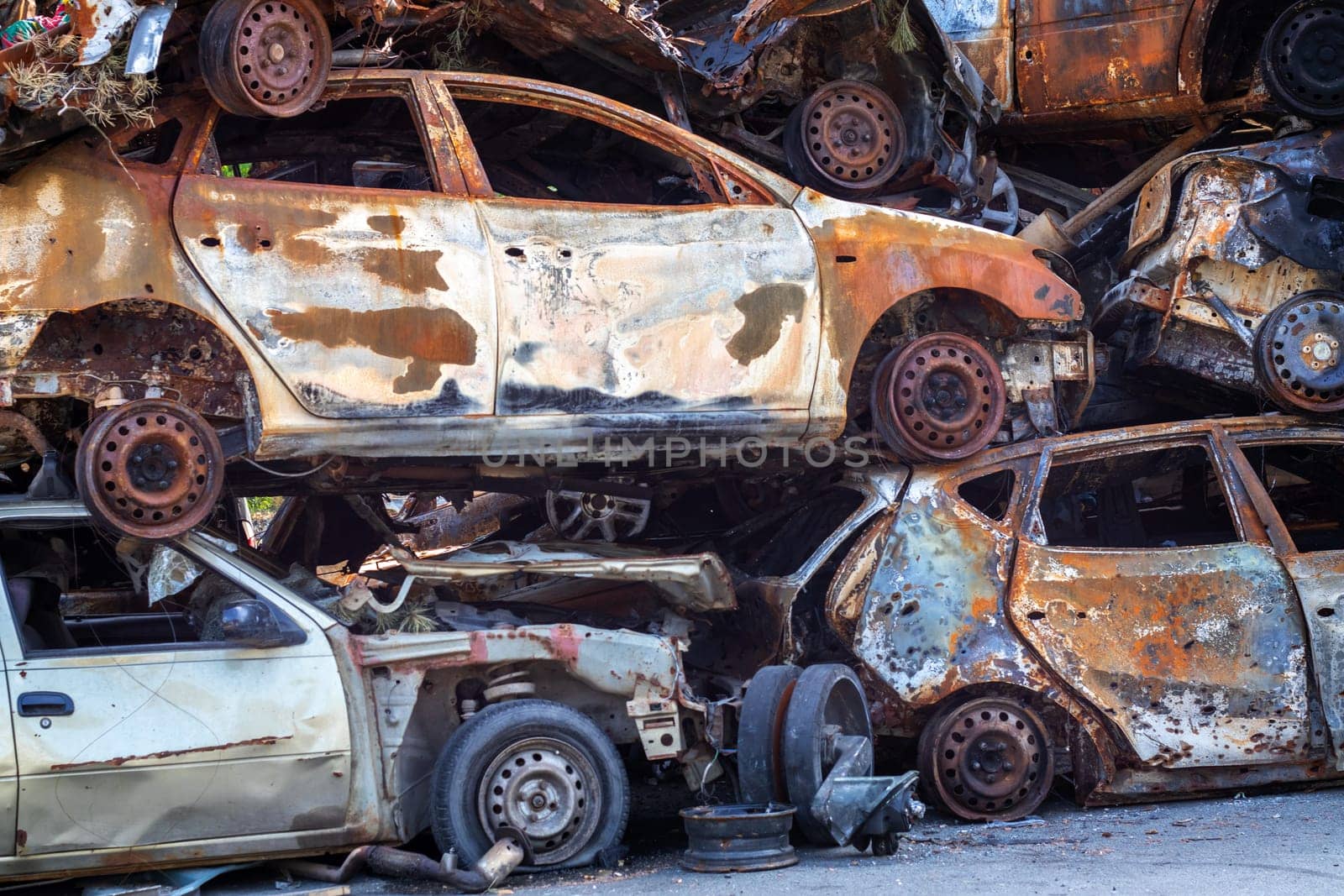 Russian invasion of Ukraine in 2022, destroyed and burned cars. Cars were beaten with shrapnel and burned. Irpensky automobile cemetery. The consequences of the war in a peaceful city near Kyiv