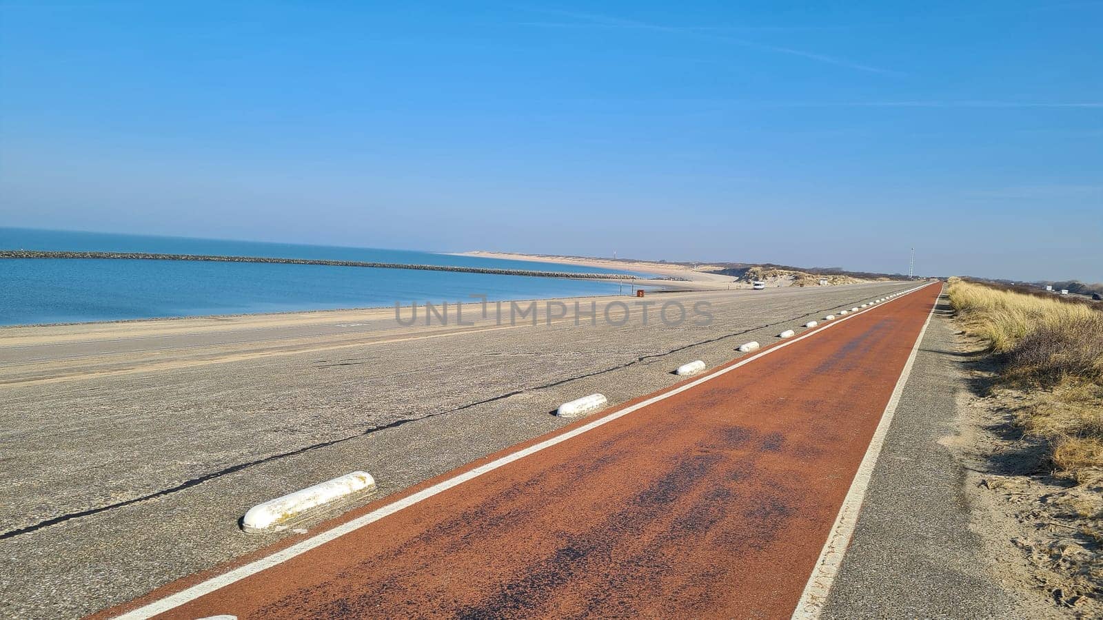 View of the resort of Port Zelande and its surroundings of the lake and dunes under a partly blue sky