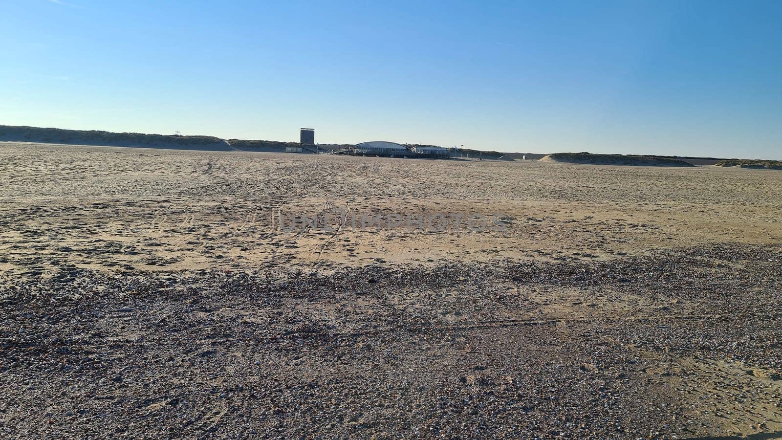 View of the resort of Port Zelande and its surroundings of the lake and dunes under a partly blue sky