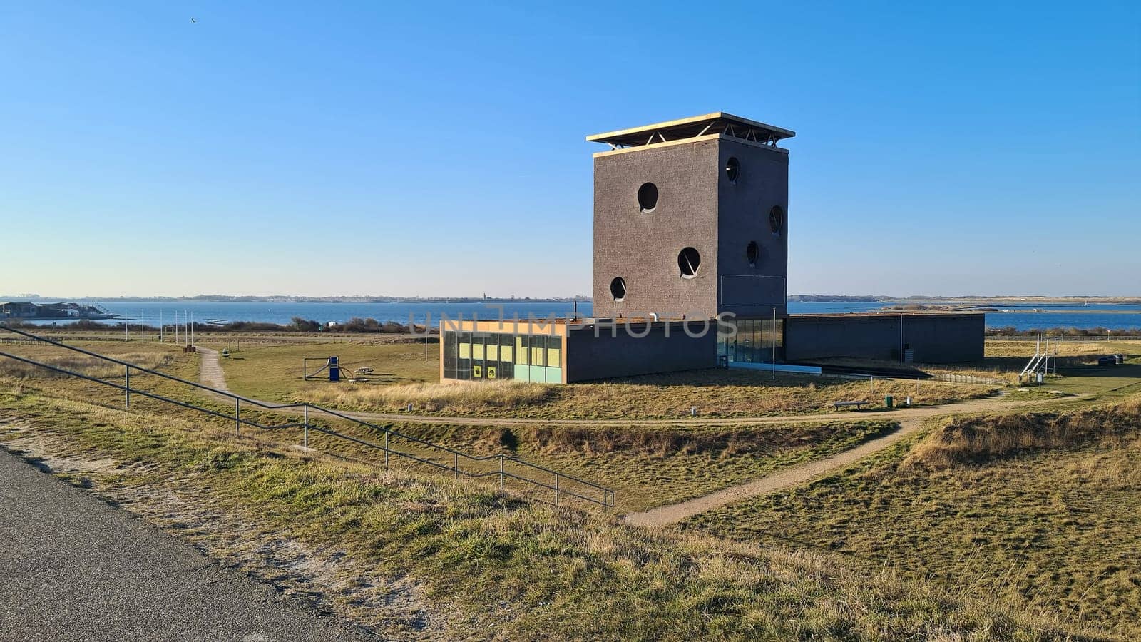 View of the resort of Port Zelande and its surroundings of the lake and dunes under a partly blue sky