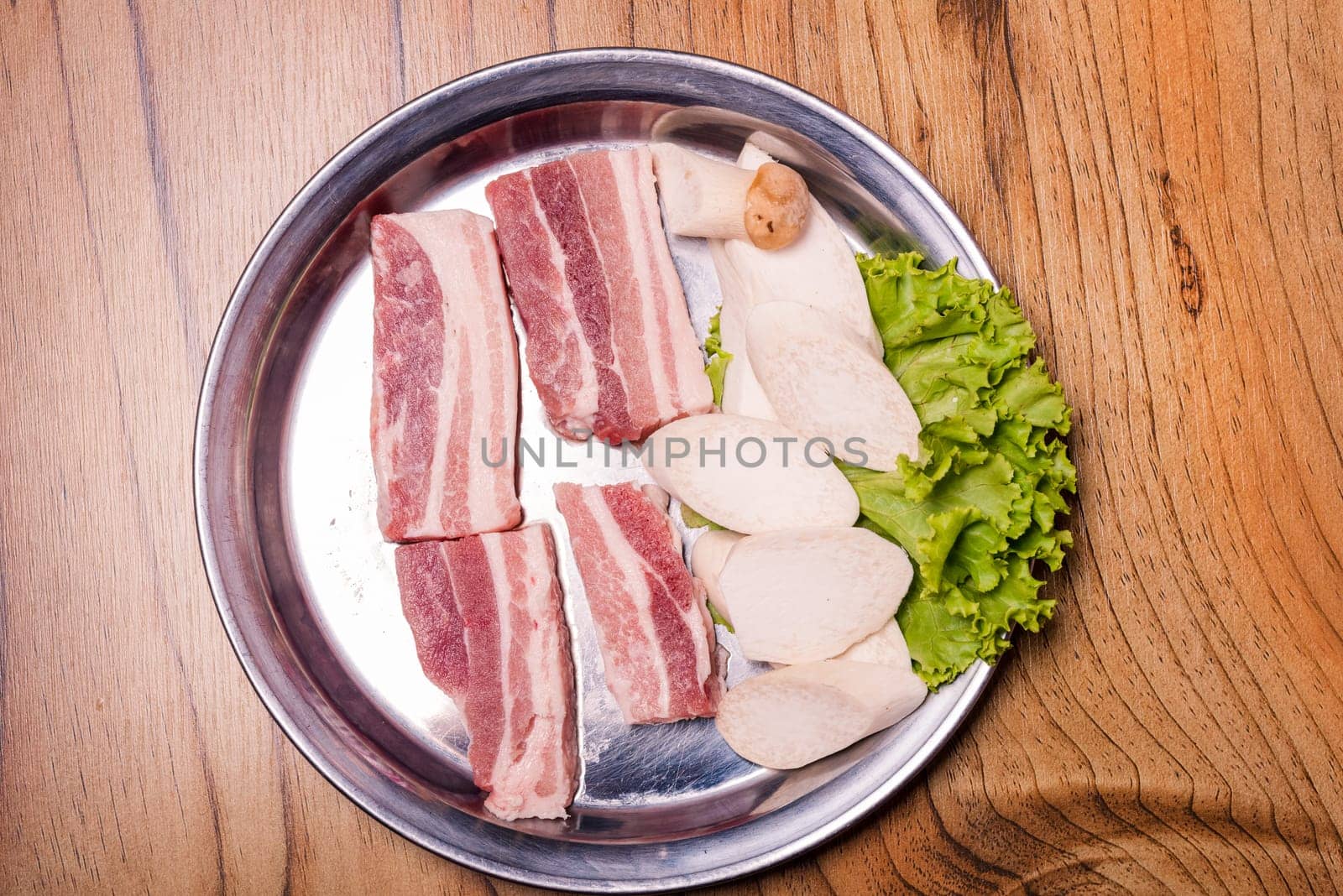 Raw pork on plate, Korean traditional style fresh pork beef belly BBQ, Japanese meat hot pot or Shabu in the restaurant, barbecue food