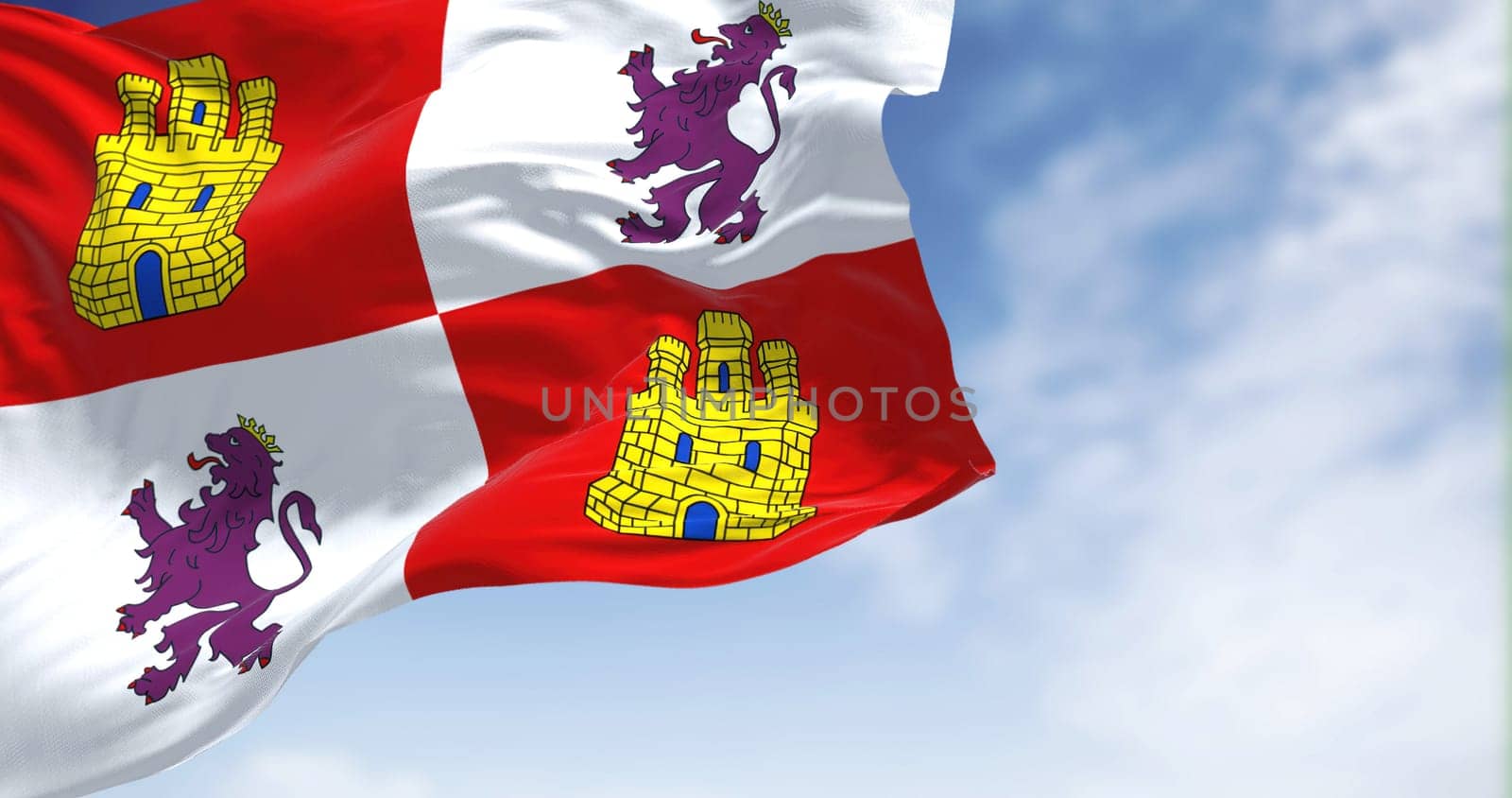 The Castile and Leon flag waving in the wind on a clear day. Castile and Leon is an autonomous community in north-western Spain.