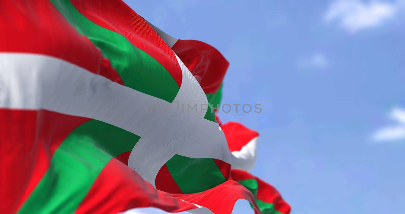 The Basque Country flag waving in the wind on a clear day. The Basque Country is an autonomous community in northern Spain