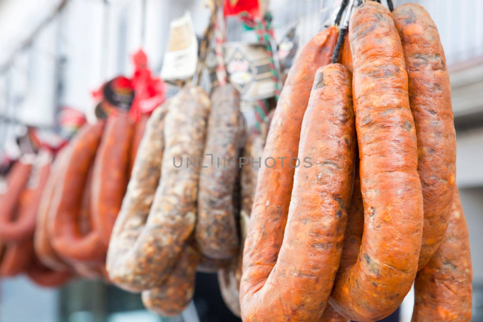Blood sausages and chorizos hanging over street market stall
