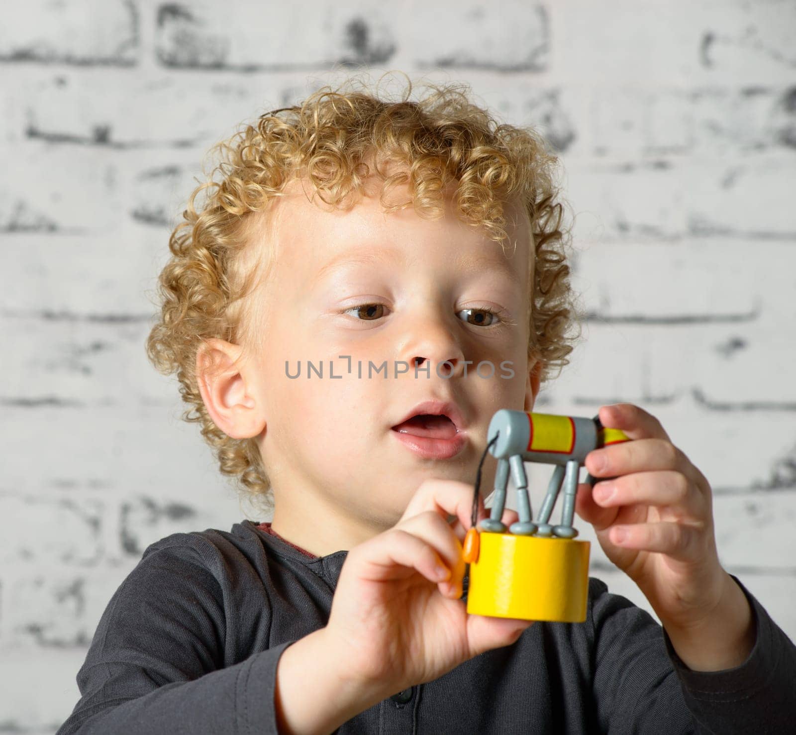 a little child plays with toy animal