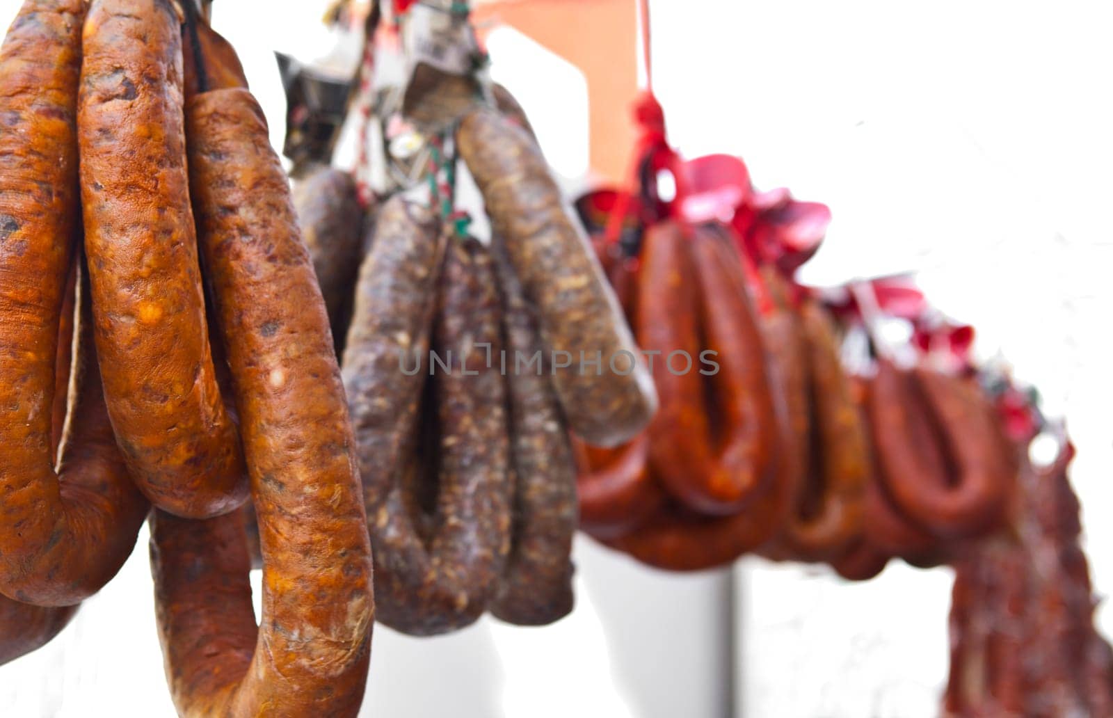 Blood sausages and chorizos hanging over street market stall